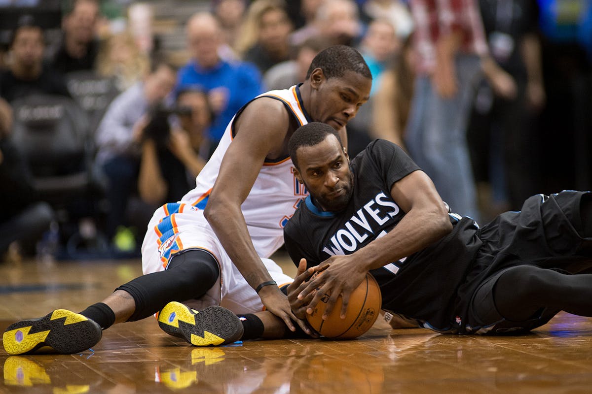 Oklahoma City Thunder forward Kevin Durant (35) and Minnesota Timberwolves forward Shabazz Muhammad (15) go down to the floor for a loose ball during 