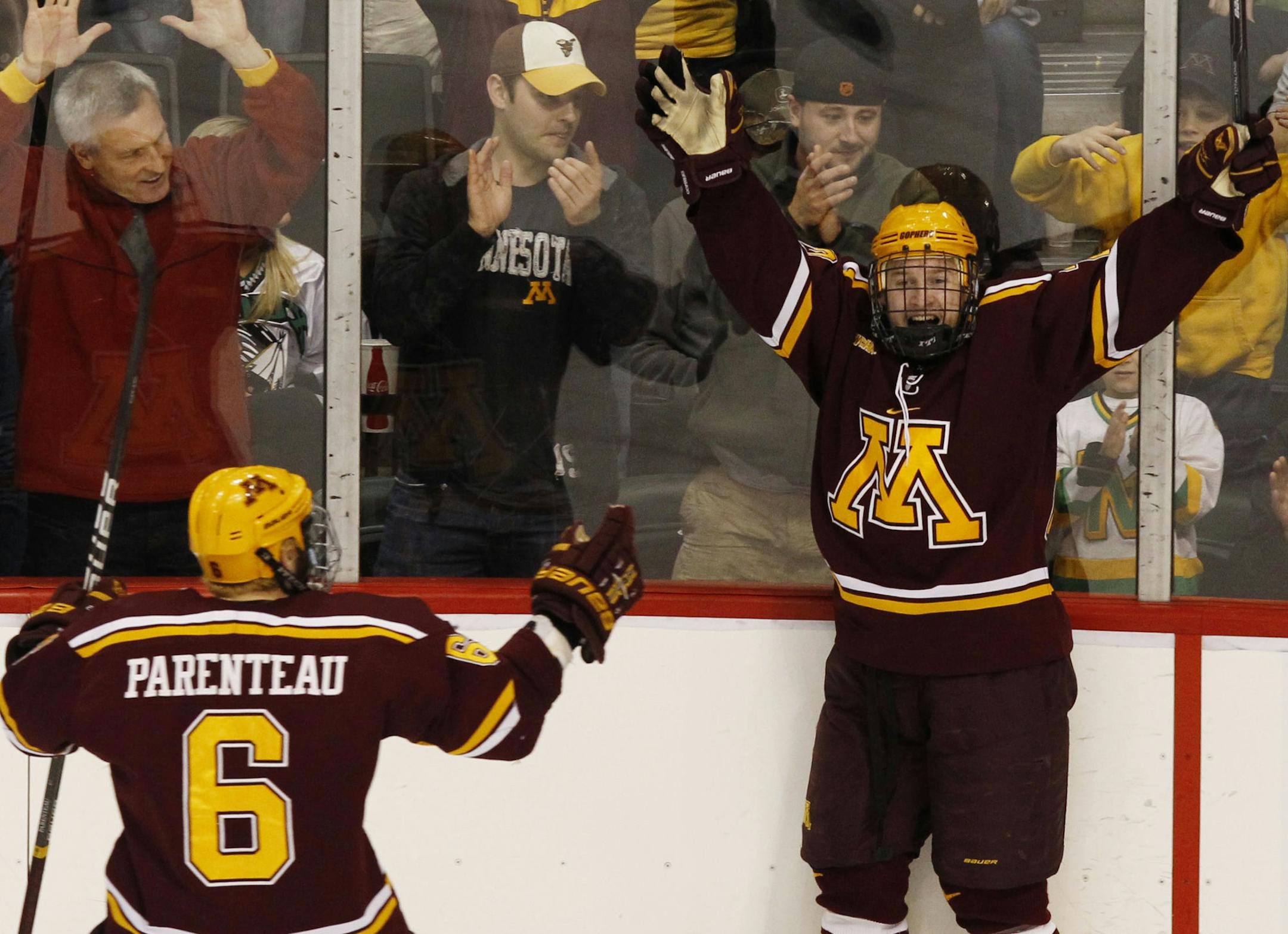 Minnesota's Travis Boyd, right, celebrates with Jake Parenteau (6) after scoring on North Dakota goalie Aaron Dell during the second period of the NCAA men's college hockey tournament West Regional final, Sunday, March 25, 2012, in St. Paul, Minn. (AP Photo/Genevieve Ross) ORG XMIT: MNGR107