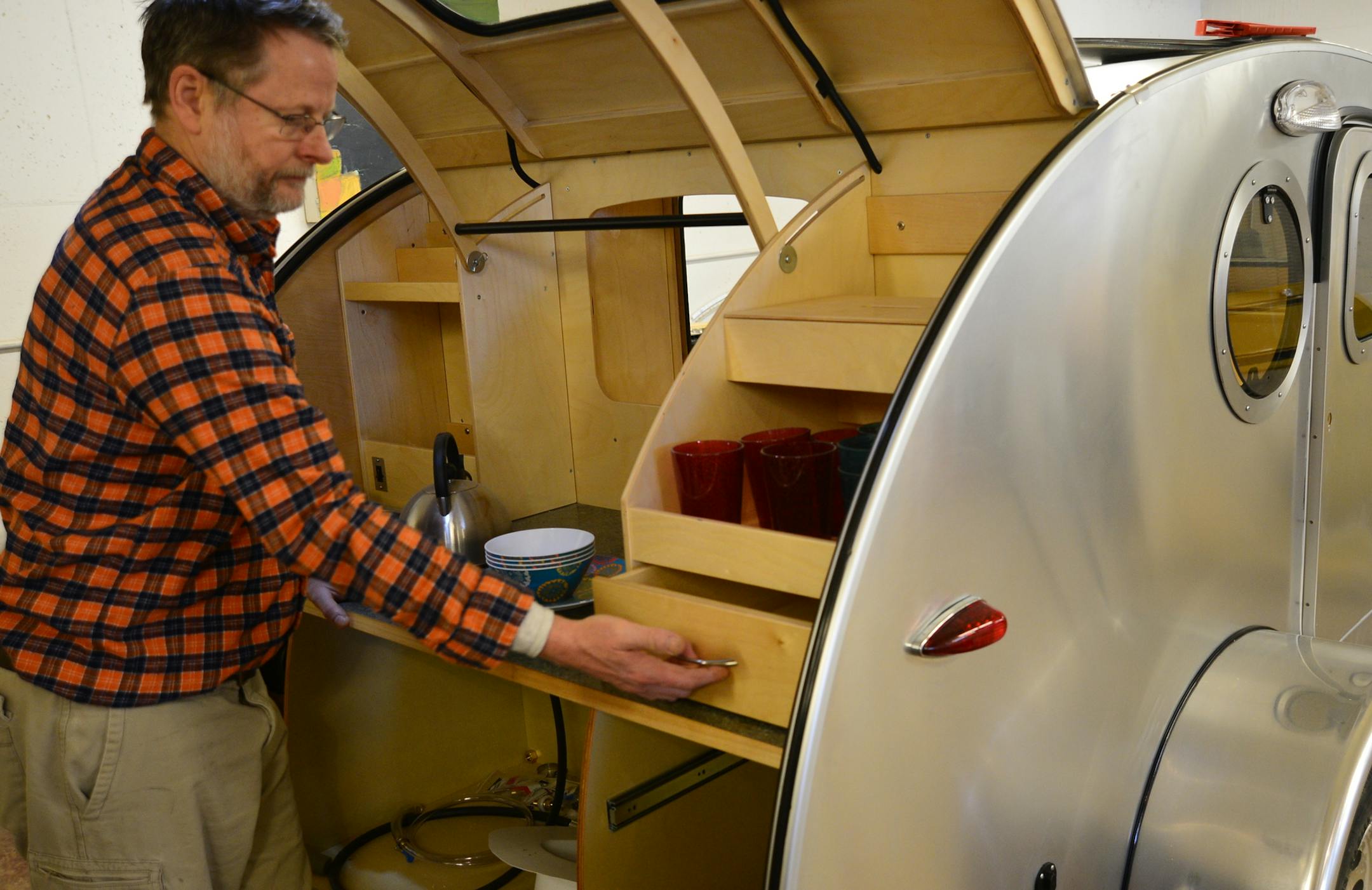 Bert Taylor started building tiny, tear-drop shaped RV trailers last year. Now he can't make enough to keep up with demand. The trailers have a kitchenette and a queen sized bed. He worked on installing a portal screen ] Richard.Sennott@startribune.com Richard Sennott/Star Tribune Minneapolis , Minn. Tuesday 2/4/2014) ** (cq)