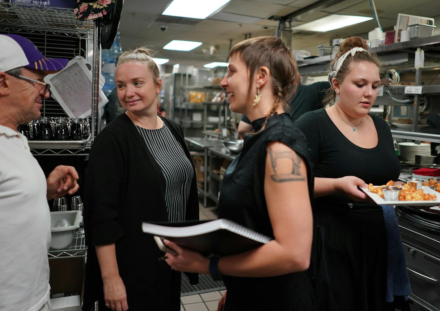 Co-owner Steve Meyer talked with Hell's Kitchen managers Kjersti Granberg, left, and Jessica Cram, center, who helped turn the restaurant around.