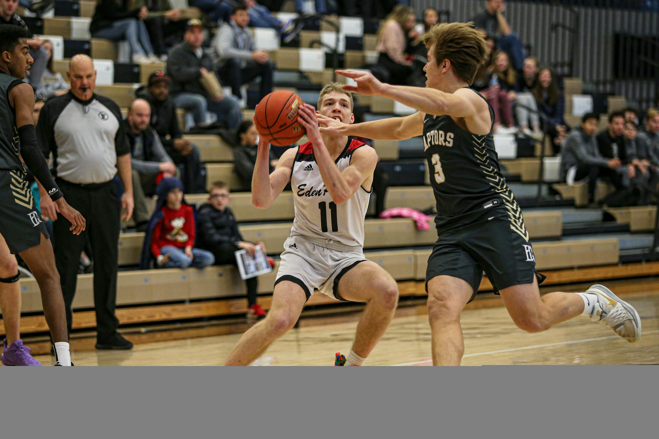 Point guard Drake Dobbs (11) is one of four Eden Prairie seniors averaging between 10.6 and 17 points per game for the unbeaten Eagles. Photo by Mark Hvidsten, SportsEngine