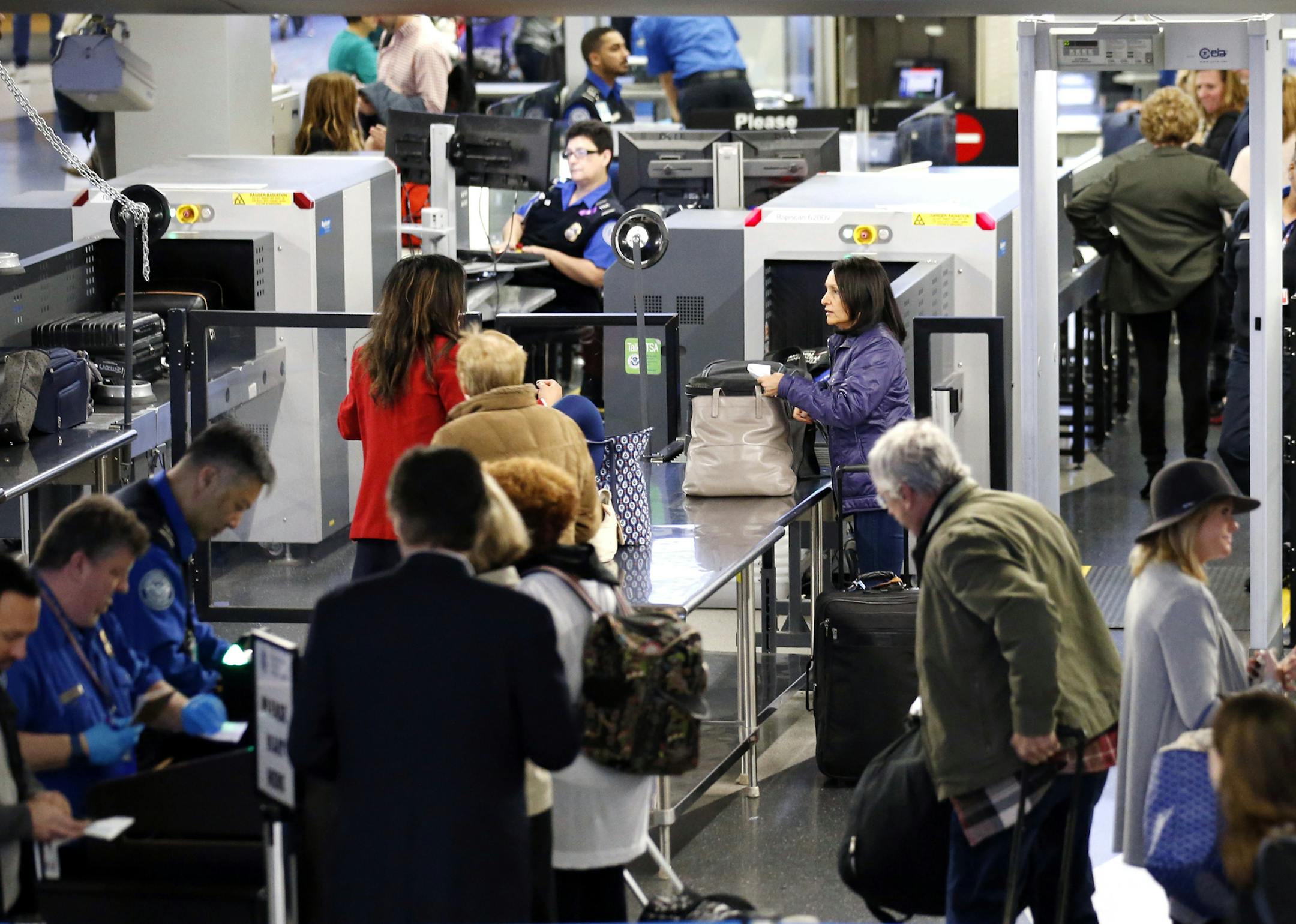 Travelers line up at a security checkpoint area in Terminal 3 at O'Hare International Airport in Chicago, Wednesday, Nov. 23, 2016. While driving remains the most popular form of transportation Thanksgiving travelers take, AAA expects just under 4 million people to fly to their holiday destinations. (AP Photo/Nam Y. Huh)