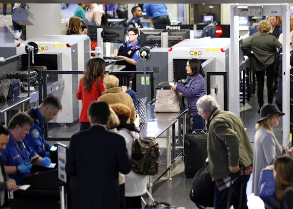 Travelers line up at a security checkpoint area in Terminal 3 at O'Hare International Airport in Chicago, Wednesday, Nov. 23, 2016. While driving rema