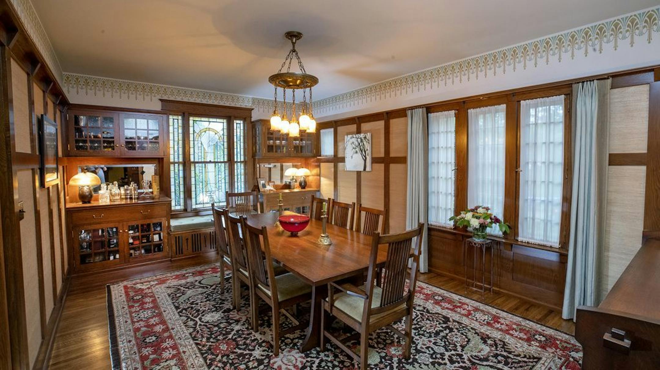 The dining room has a new bank of cabinets that blend with the room's original features.