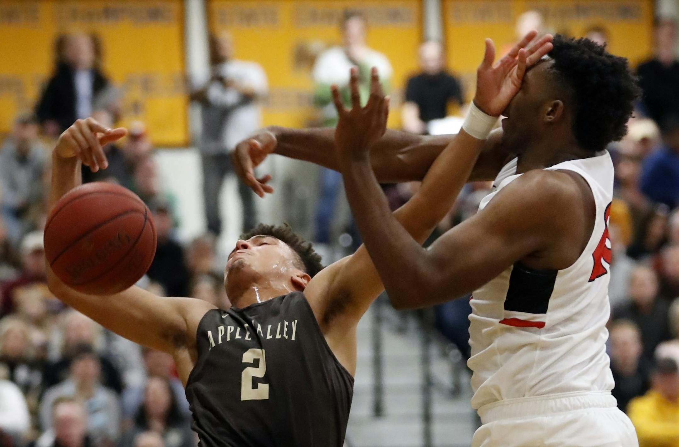 Nathan Macho(2) is defended by JaVonni Bickham(23) of Minnehaha.