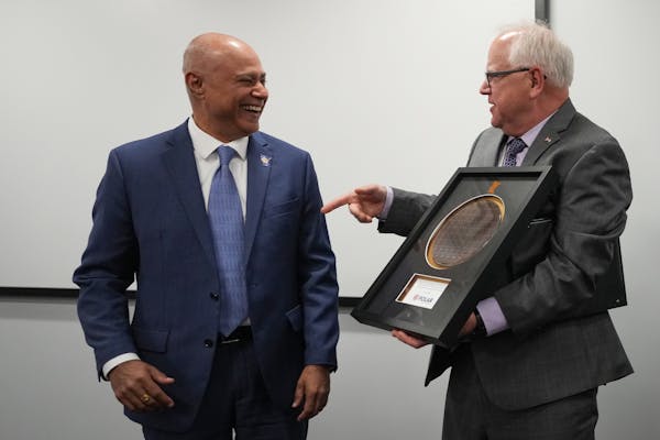 Polar Semiconductor President Surya Iyer presents Minnesota Governor Tim Walz with an oversized representation of an automobile chip during a visit Tu