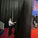 A campaign worker works on the set for the spin corner for the President Barack Obama campaign in the media center ahead of Monday's presidential deba