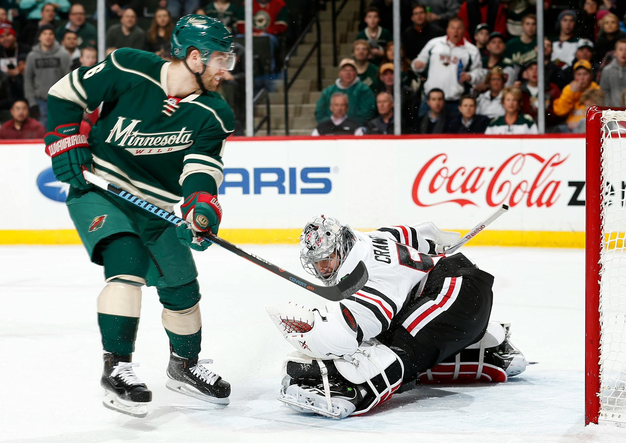Jason Zucker (16) shot the puck past Chicago goalie Corey Crawford (50) for a goal in the first period.