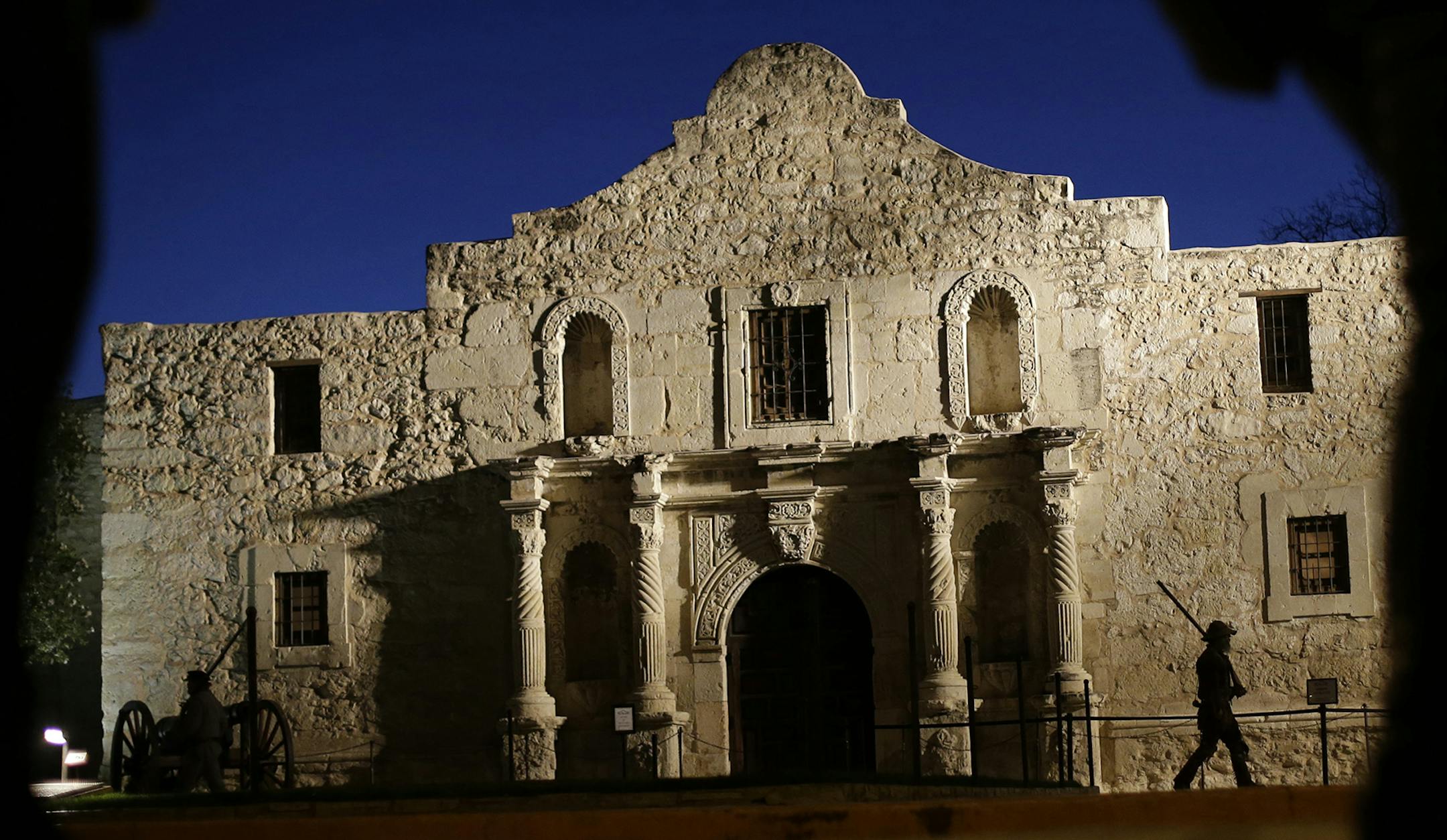 **STORY BY MIKE GRACZYK DEVELOPING** File - In this March 6, 2013, file photo, Dan Phillips, a member of the San Antonio Living History Association, patrols the Alamo during a pre-dawn memorial ceremony to remember the 1836 Battle of the Alamo and those who fell on both sides, in San Antonio. (AP Photo/Eric Gay, File) ORG XMIT: DN101