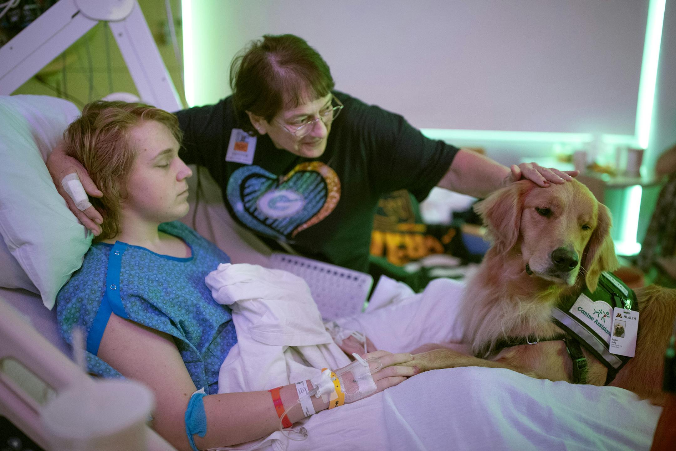 Judy Nelson, rubbed therapy dog "Rocket" head as he visited A.J. Nelson, 17, of Superior, Wisconsin in his hospital room.] Jerry Holt • Jerry.Holt@startribune.com Rocket the new service dog at the U of M Masonic Children's Hospital is unique in that it has been specially trained to stay with kids and keep them calm through medical procedures, etc. Therapy dogs can smell/spot seizures and diabetic comas for chronically ill patients. Om Tuesday afternoon Rocket visited patients at the hospi