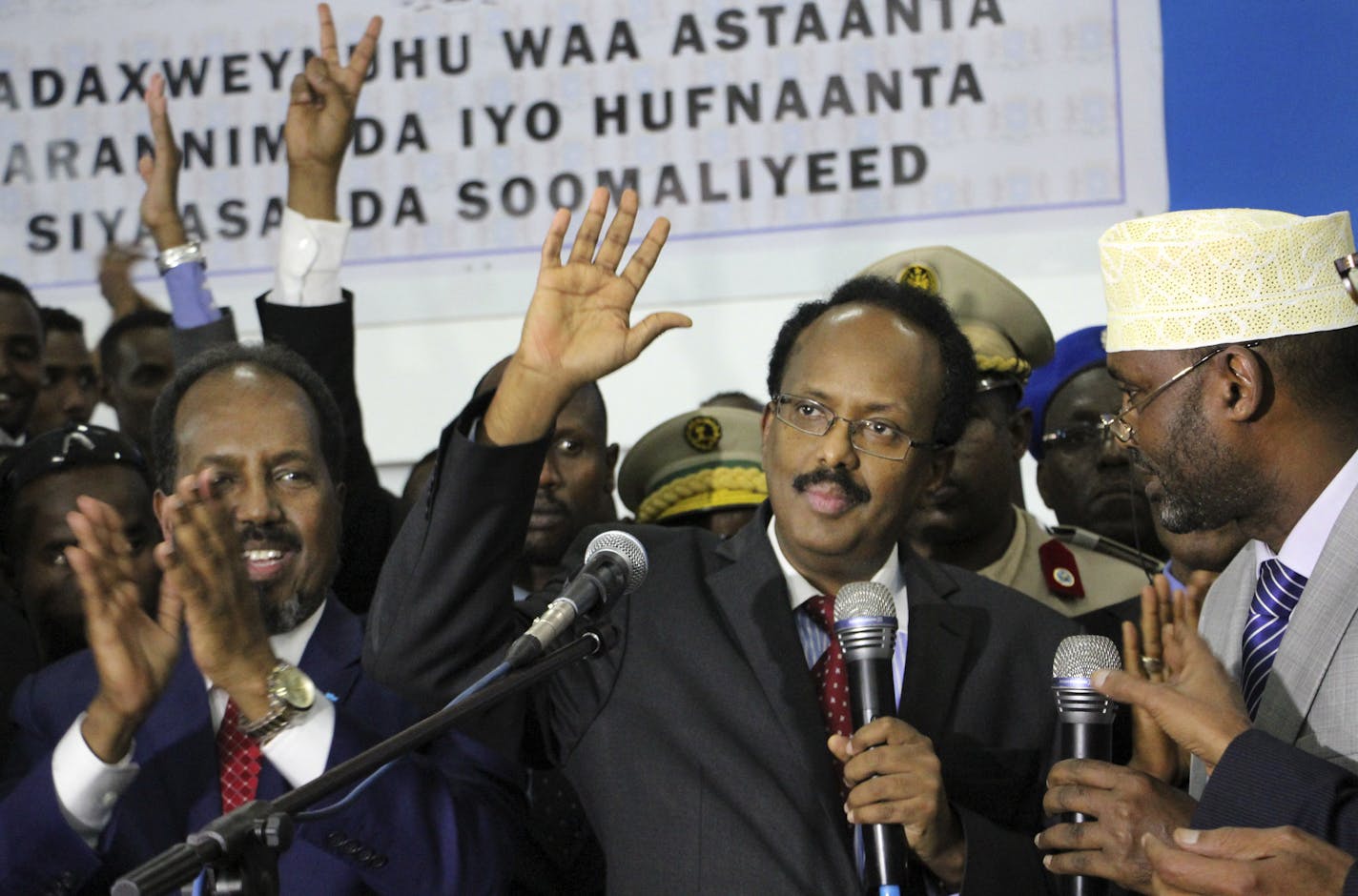 New Somali President Mohamed Abdullahi Mohamed, known by his nickname &#x201c;Farmajo,&#x201d; second right, waves to supporters as he is joined by incumbent President Hassan Sheikh Mohamud, left, after winning the election in Mogadishu, Somalia, on Wednesday. Farmajo, who holds dual Somali-U.S. citizenship, immediately took the oath of office as the long-chaotic country moved toward its first fully functioning central government in a quarter-century.