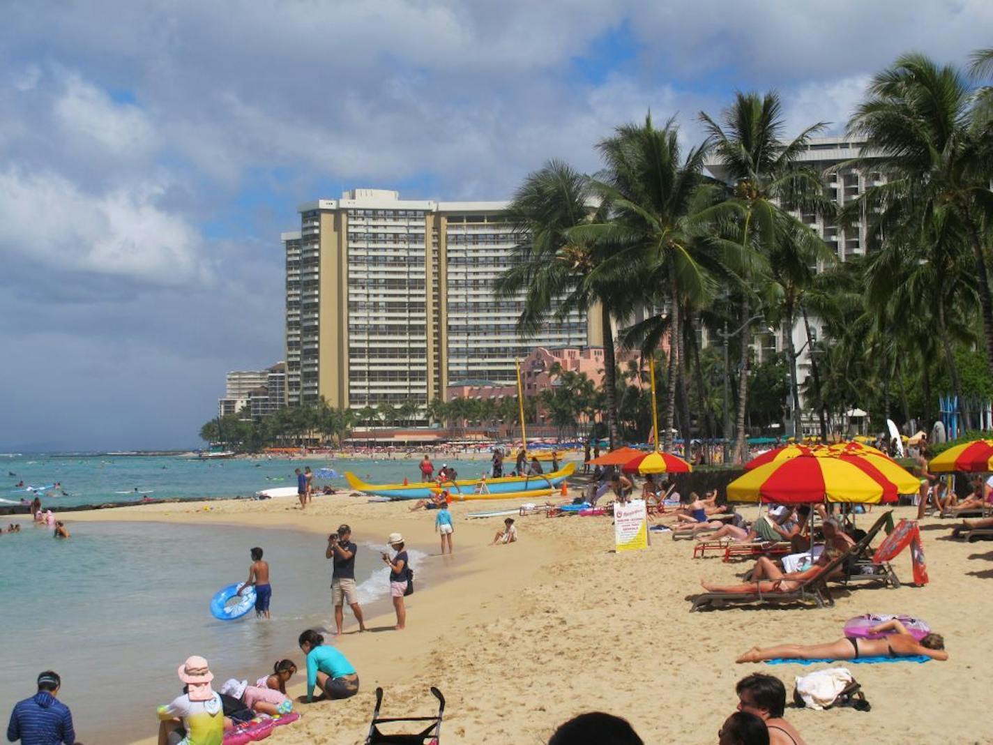 People lounge on Waikiki's beaches in Honolulu on Wednesday, Aug. 6, 2014.