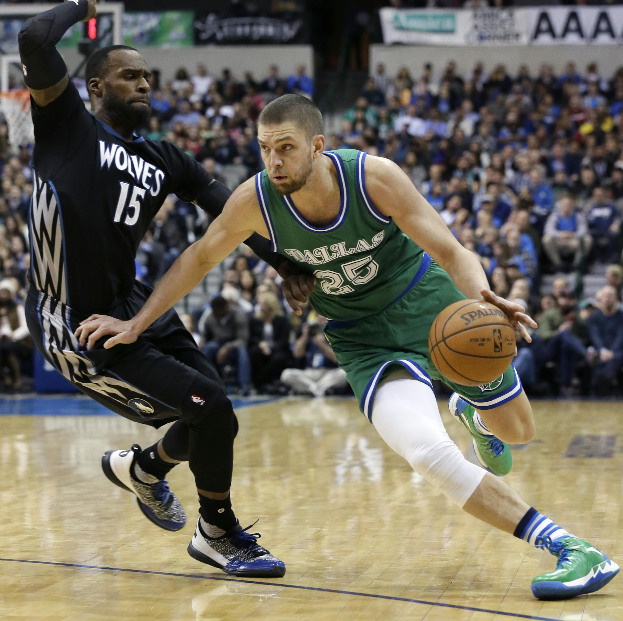 Dallas Mavericks forward Chandler Parsons (25) drives against Minnesota Timberwolves forward Shabazz Muhammad (15) during the second half of an NBA basketball game Wednesday, Jan. 20, 2016, in Dallas. The Mavericks won 106-94 in overtime. (AP Photo/LM Otero)