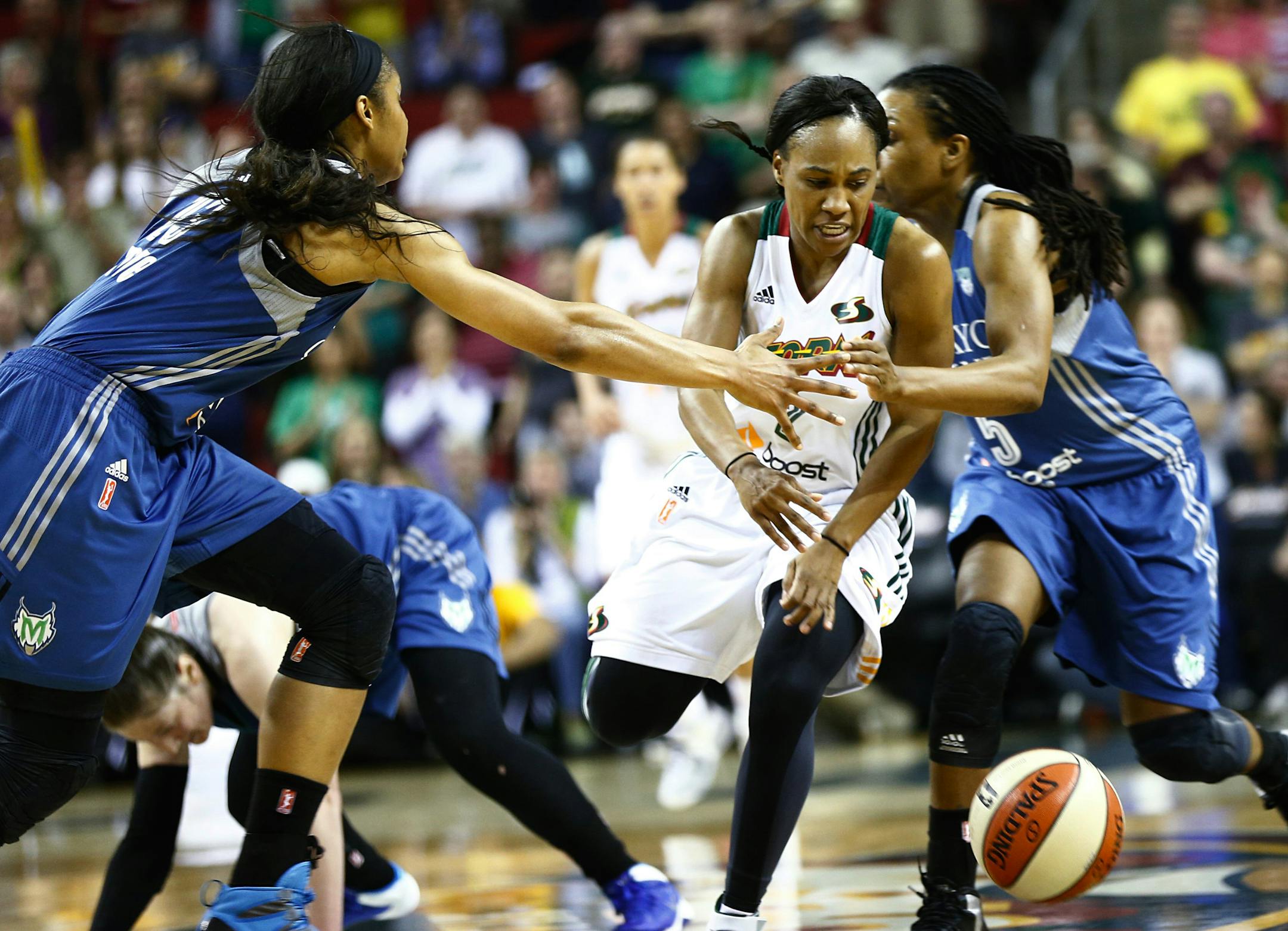Storm guard Temeka Johnson (2) makes a break through Lynx players Maya Moore, left, and Tan White, right, in the second half at KeyArena on Friday, June 6, 2014. The Storm beat the Lynx 65-62 in a close game to improve to a 3-6 win-loss record for the season. (AP Photo/The Seattle Times, Lindsey Wasson)