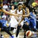 Storm guard Temeka Johnson (2) makes a break through Lynx players Maya Moore, left, and Tan White, right, in the second half at KeyArena on Friday, Ju