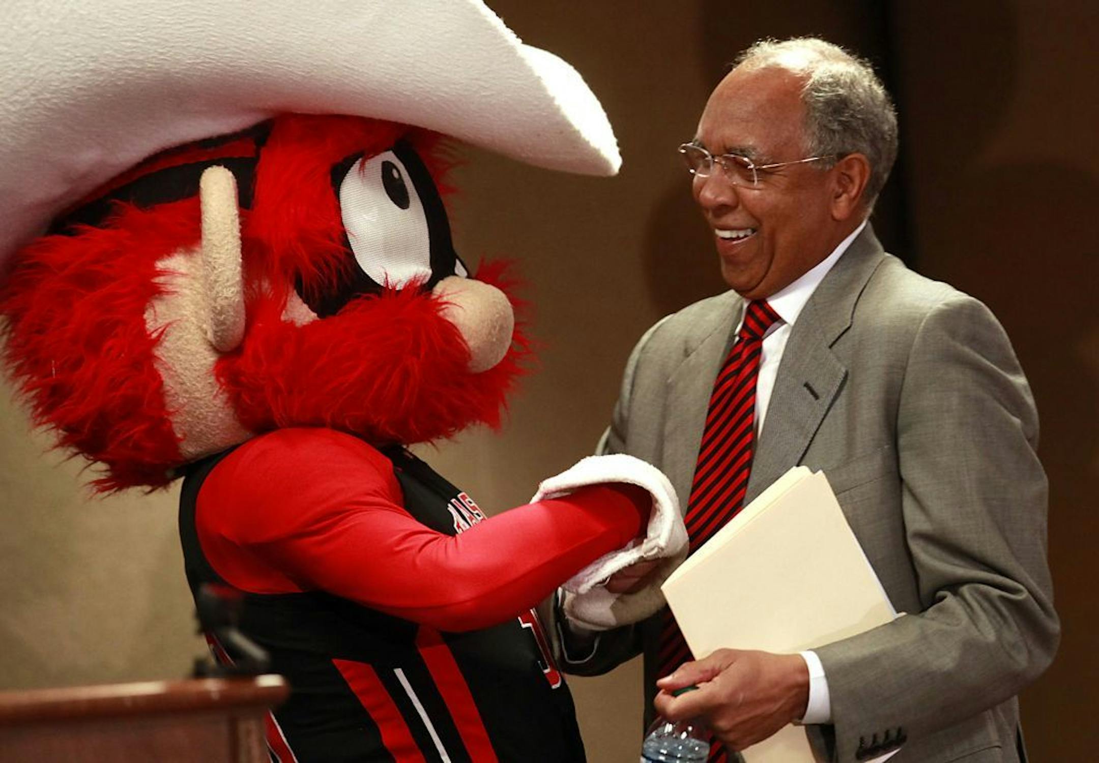 Texas Tech's mascot Raider Red welcomes Tubby Smith to the stage before Smith was introduced as the new men's basketball coach at Texas Tech during an NCAA college news conference in Lubbock, Texas, Tuesday, April 2, 2013.