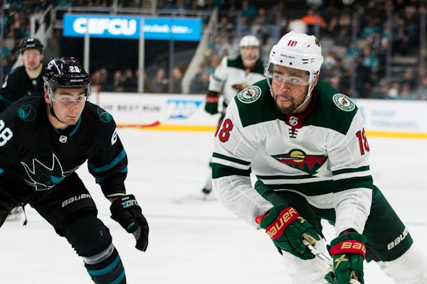 Minnesota Wild's Jordan Greenway (18) looks to pass as San Jose Sharks' Timo Meier (28) defends in the second period of an NHL hockey game, Thursday, 