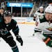Minnesota Wild's Jordan Greenway (18) looks to pass as San Jose Sharks' Timo Meier (28) defends in the second period of an NHL hockey game, Thursday, 