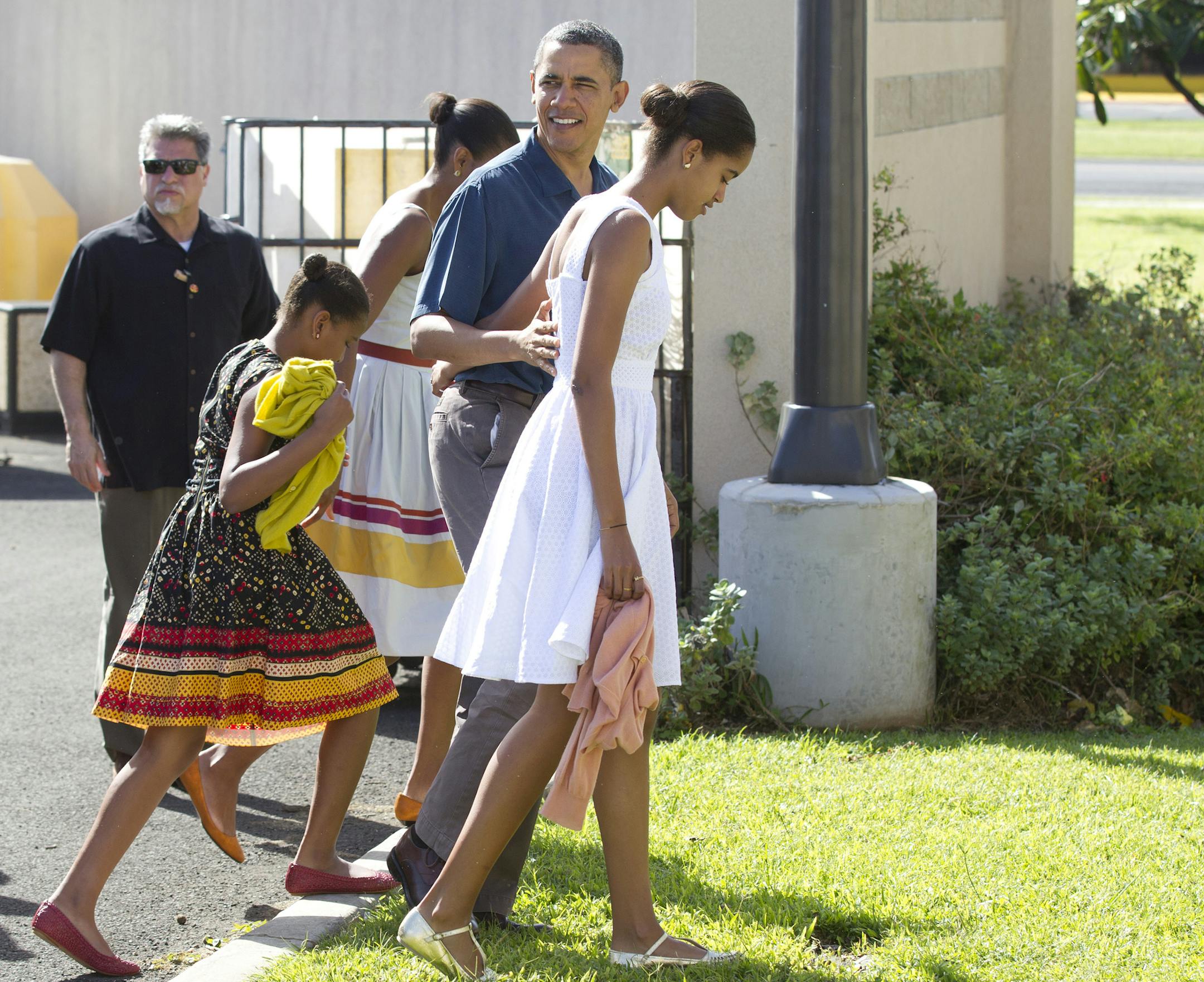 President Barack Obama, first lady Michelle Obama and their daughters Malia and Sasha arrive for Christmas service at the Kaneohe bay Chapel on Marine Corps Base Hawaii , Sunday, Dec. 25, 2011, in Kaneohe, Hawaii. (AP Photo/Carolyn Kaster)