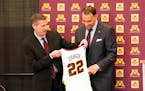 New Gophers men’s basketball coach Ben Johnson receives his own number from athletic director Mark Coyle on March 23.
