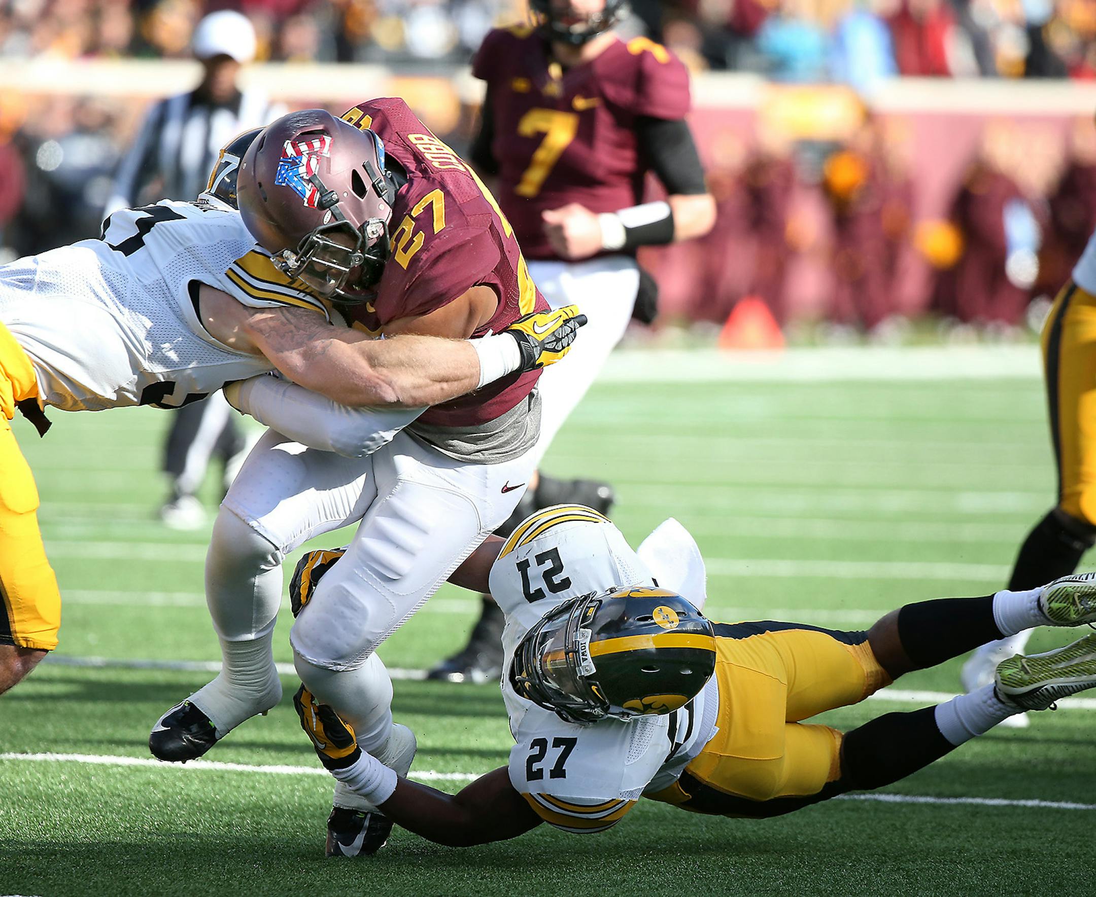 Minnesota's running back David Cobb (27) rushed for yards despite defensive pressure by Iowa's defensive back John Lowdermilk (37), left, and defensive back Jordan Lomax (27) just short of the end zone in the second quarter as the Gophers took on the Iowa Hawkeyes, Saturday, November 8, 2014 at TCF Stadium in Minneapolis, MN. ] (ELIZABETH FLORES/STAR TRIBUNE) ELIZABETH FLORES • eflores@startribune.com