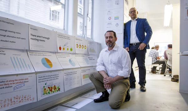 Wes LeBlanc, analytics director, and Todd Heiser, co-creative director and principal, with data used to design the new office space Wednesday, Aug. 1,