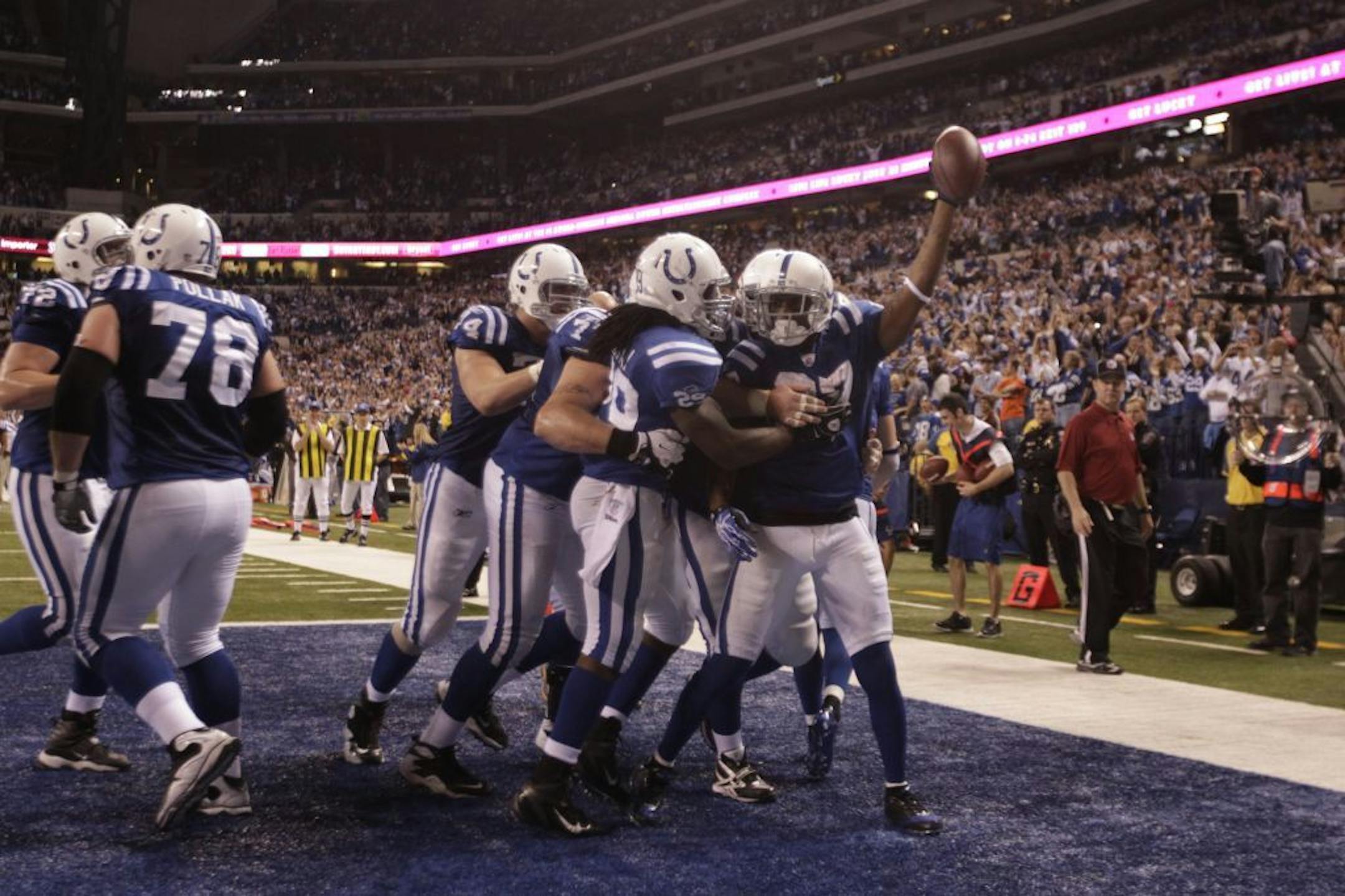 Indianapolis Colts' Reggie Wayne (87)reacts with teammates after making the game winning catch against Houston Texans' Kareem Jackson during the fourth quarter of an NFL football game Thursday, Dec. 22, 2011, in Indianapolis.