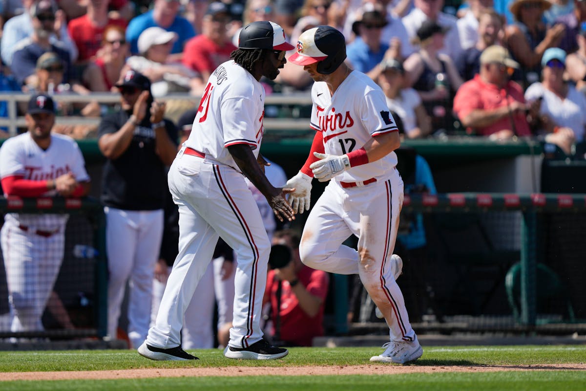 Twins shortstop Kyle Farmer was greeted by third base coach Tommy Watkins after hitting a two-run homer in the second inning Friday.