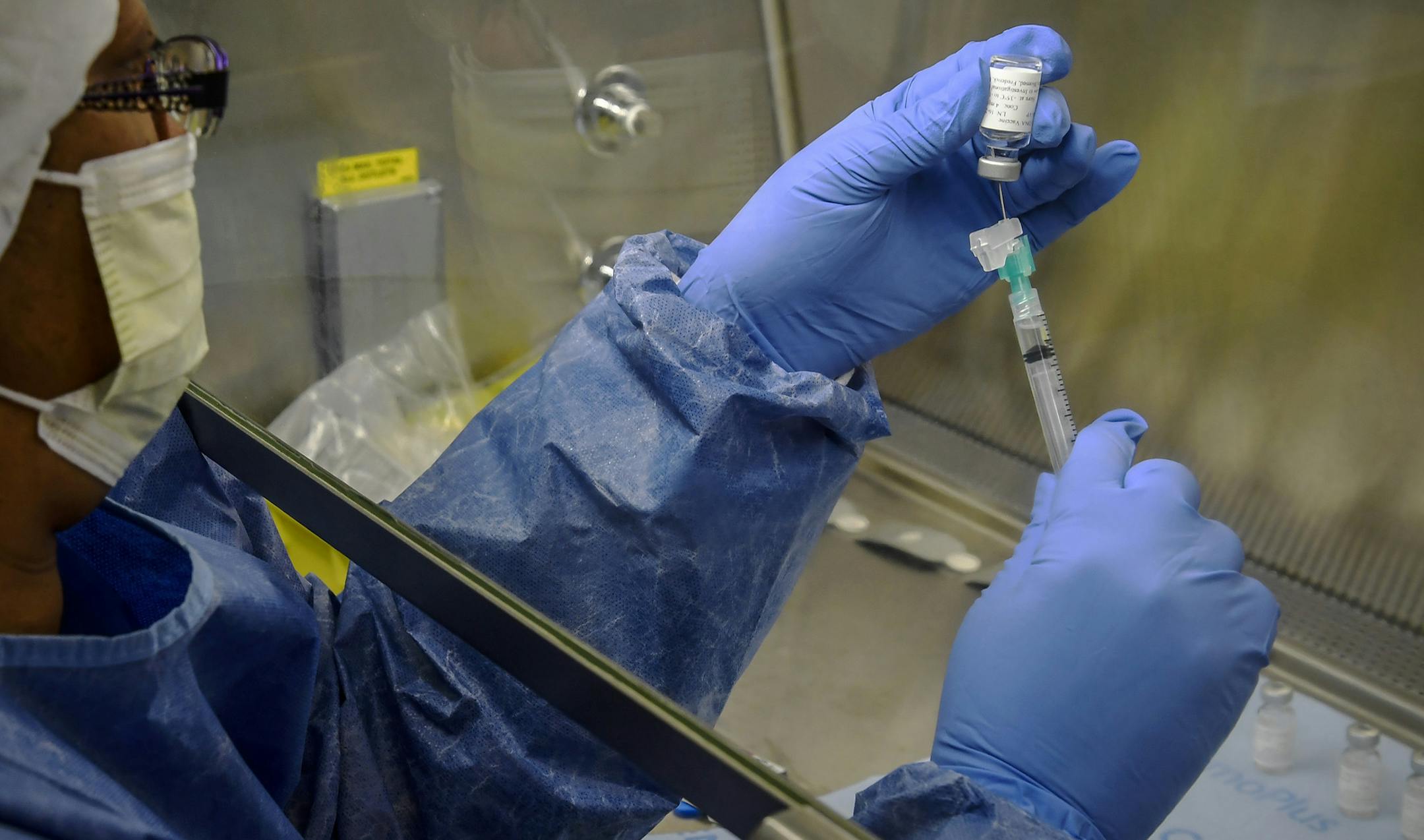 Pharmacy technician Sandra Crutcher prepares a dose of Zika vaccine for use in a clinical trial at the University of Maryland School of Medicine in Baltimore. MUST CREDIT: Washington Post photo by Bill O'Leary.