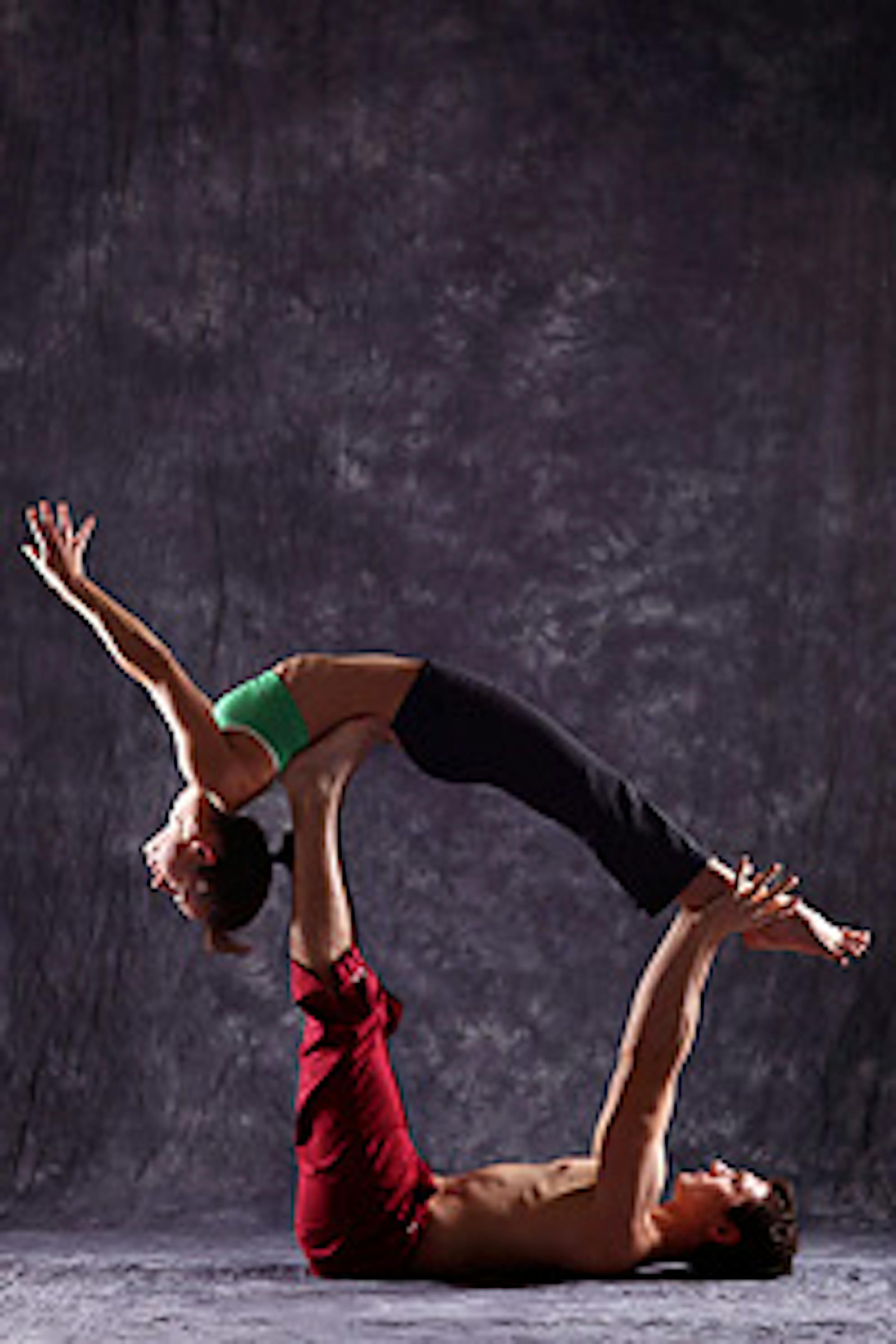 Yoga models Jessica Rosenberg and Adam Ramerth demonstrate a partner-lifted upper-back arch position.