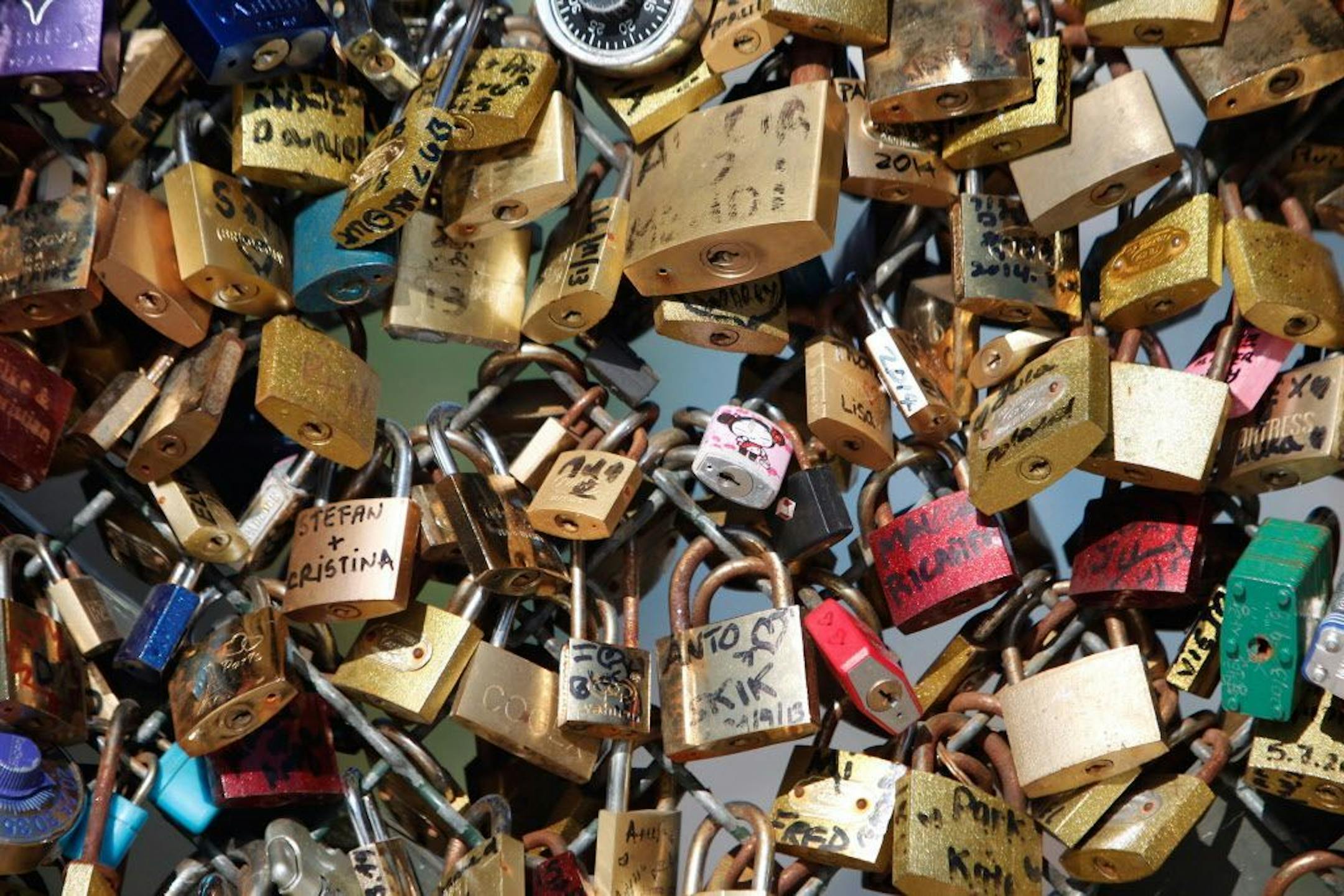FILE - This April 9, 2014 file photo shows love locks fixed on the Pont des Arts bridge in Paris, France. Any hope that the love locks that cling to Paris� famed Pont des Arts bridge would last forever _ will be unromantically dashed by the city council who plan to dismantle them Monday _ for good.