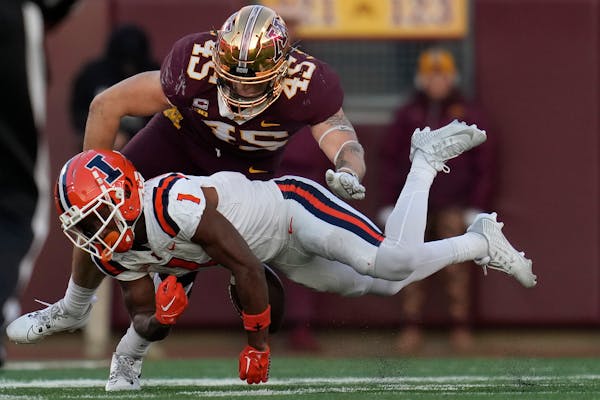 Illinois wide receiver Isaiah Williams (1) fumbles the football after catching a pass as Minnesota linebacker Cody Lindenberg (45) tackles him during 