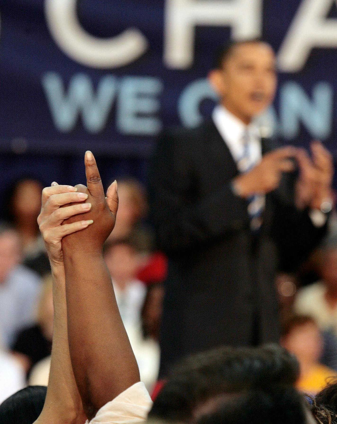 Ask me: Two women raised their hands hoping Sen. Barack Obama would answer their question during a rally Monday in Troy, Mich.