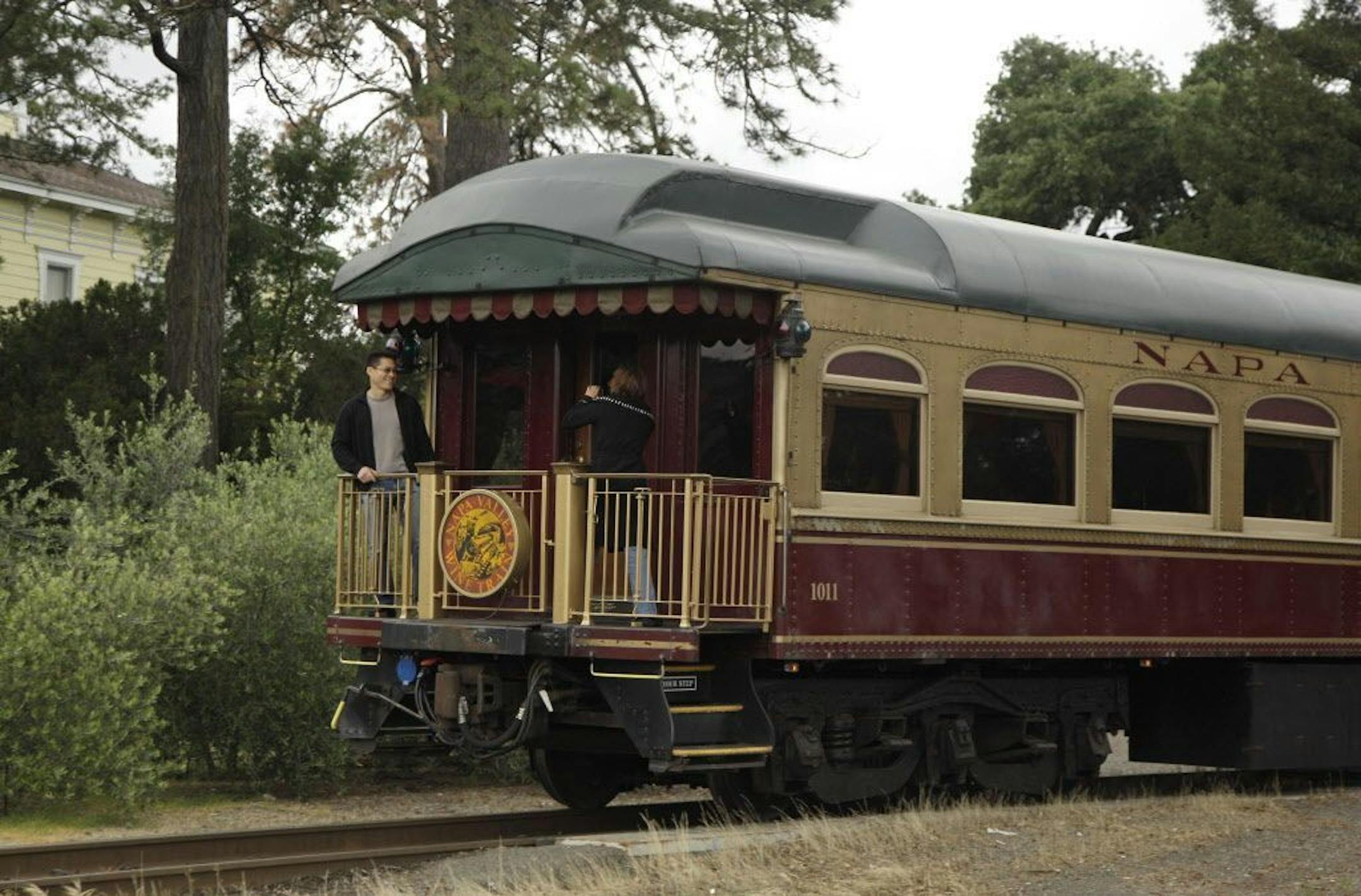 FILE - In this June 2, 2011 file photo, a couple takes pictures at the back of the Napa Valley Wine Train as it makes its way through St. Helena, Calif.