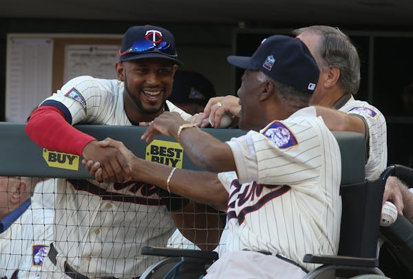 Twin Aaron Hicks came over to say hi to former Twin Jim "Mudcat" Grant before the 1965 team was honored. ] (KYNDELL HARKNESS/STAR TRIBUNE) kyndell.har