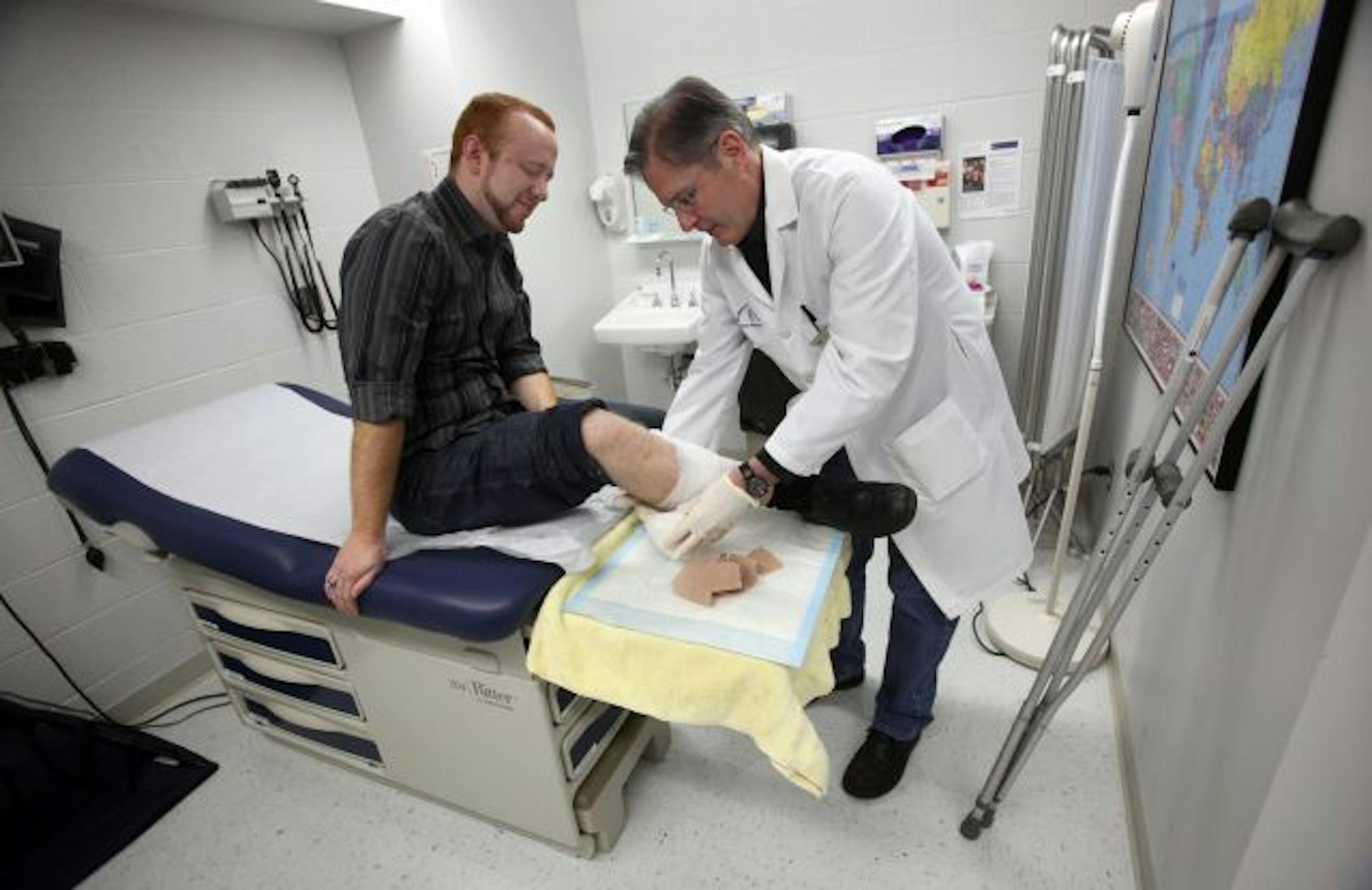 An experiment with mandatory coverage: St. Thomas had dropped mandatory coverage when the paperwork became overwhelming. But the school reinstituted mandatory coverage in 2007. Senior Kevin Hampton got treatment for a leg infection from Dr. Tom Thul.