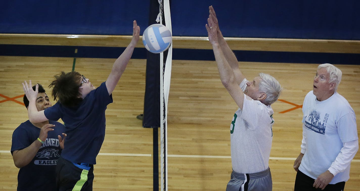 Leroy Martinson right blocked a shot attempt as teammate Gerry Vande Garde looked on. A group of senior citizens who call themselves "Born Again Jocks" played volleyball with sophomore students at Kennedy High school Monday March 2, 2015 in Bloomington, Minnesota. The team includes seniors who have been selected to play in the upcoming Senior Olympics this summer.] Jerry Holt/ Jerry.Holt@Startribune.com