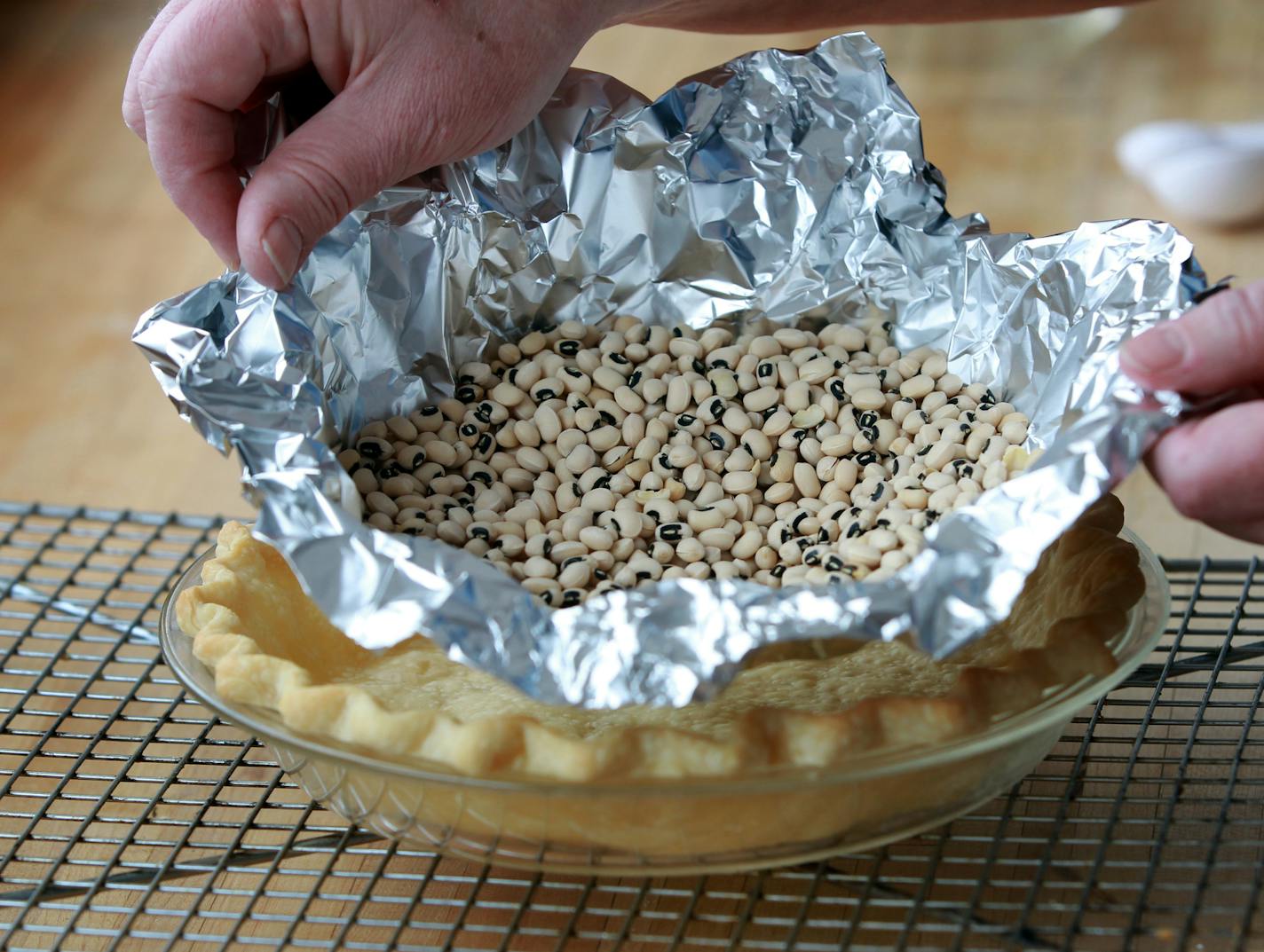 Foil and beans on the crust while you bake it keeps it from bubbling up. Baking Central Illustration for Taste cover, lemon meringue pie, and the step-by-step of making filling and whipping and a lofty meringue for a lemon pie by Kim Ode ] TOM WALLACE &#x2022; twallace@startribune.com Assignments #20027967A March 6, 2013 SLUG: 168963 BAKING031413 EXTRA INFORMATION: Baking Central by Lee Dean and Kim Ode.