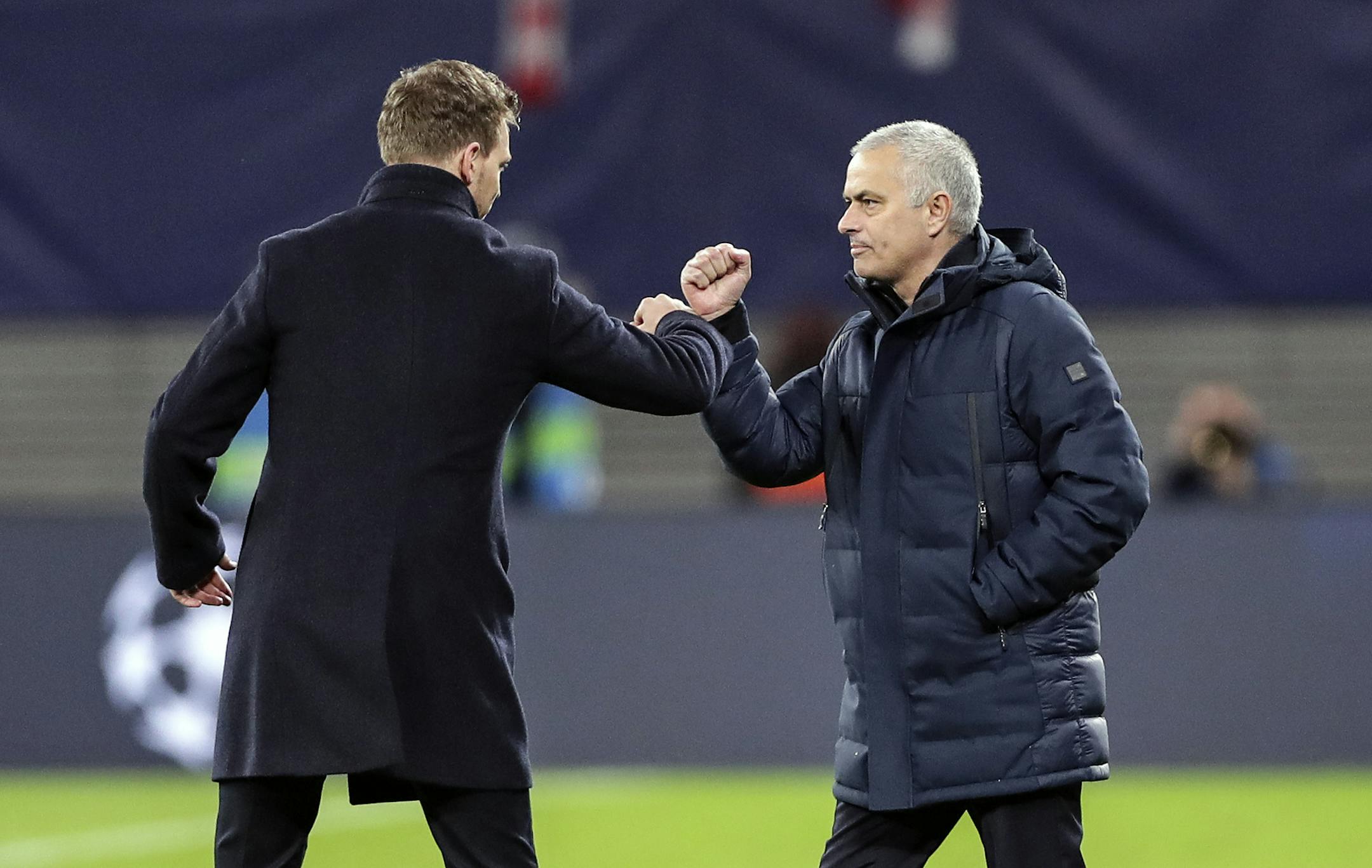 No more handshakes: at a soccer match in Germany earlier this week, Tottenham's manager Jose Mourinho, right, and Leipzig's head coach Julian Nagelsmann touched forearms due to the coronavirus outbreak.