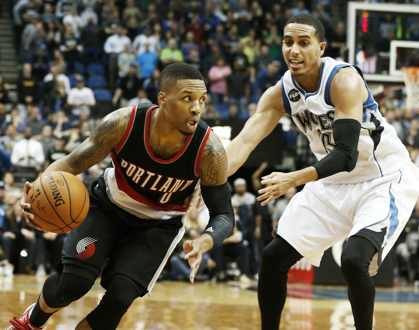 Portland Trail Blazers&#xed; Damian Lillard, left, drives on Minnesota Timberwolves&#xed; Kevin Martin in the second half of an NBA basketball game, Monday, Nov. 2, 2015, in Minneapolis. The Trail Blazers won 106-101. (AP Photo/Jim Mone)