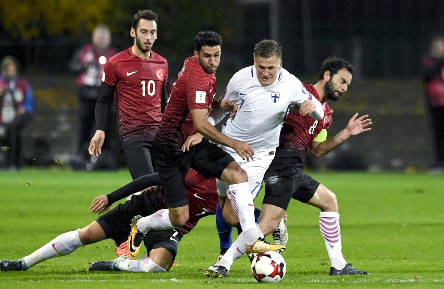 Finland's Robin Lod, second right vies for the ball with Turkey's Hakan Calhanoglu, left, Ismail Koybasi, centre left, Okay Yokuslu, on the ground, and Selcuk Inan right, during the World Cup 2018 Group I qualification soccer match between Finland and Turkey in Turku, Finland, Monday, Oct. 9, 2017. (Antti Aimo-Koivisto/Lehtikuva via AP) ORG XMIT: LON822