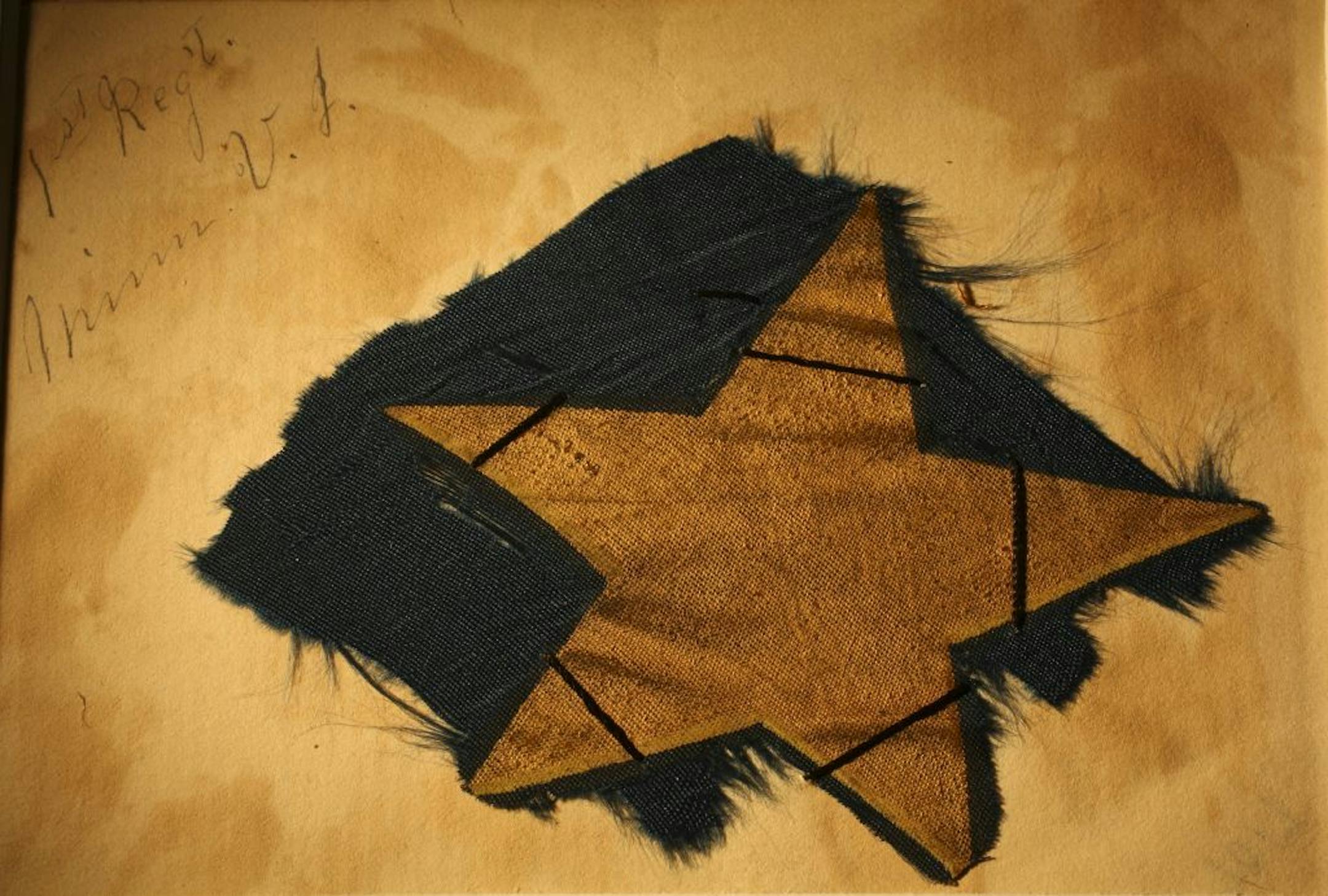 A fragment of the First Minnesota Volunteer Infantry Regiment flag carried at the Battle of Gettusburg. During the Battle of Gettysburg, 17 color bearers were shot down while carrying the flag and it was torn to shreds by rebel bullets. Sgt. George Buckman of Comapny G had possession of the flag's remnants after the war. The flag fragment, as well as Buckman's papers are in the collection of the Minnesota Historical Society in St. Paul.