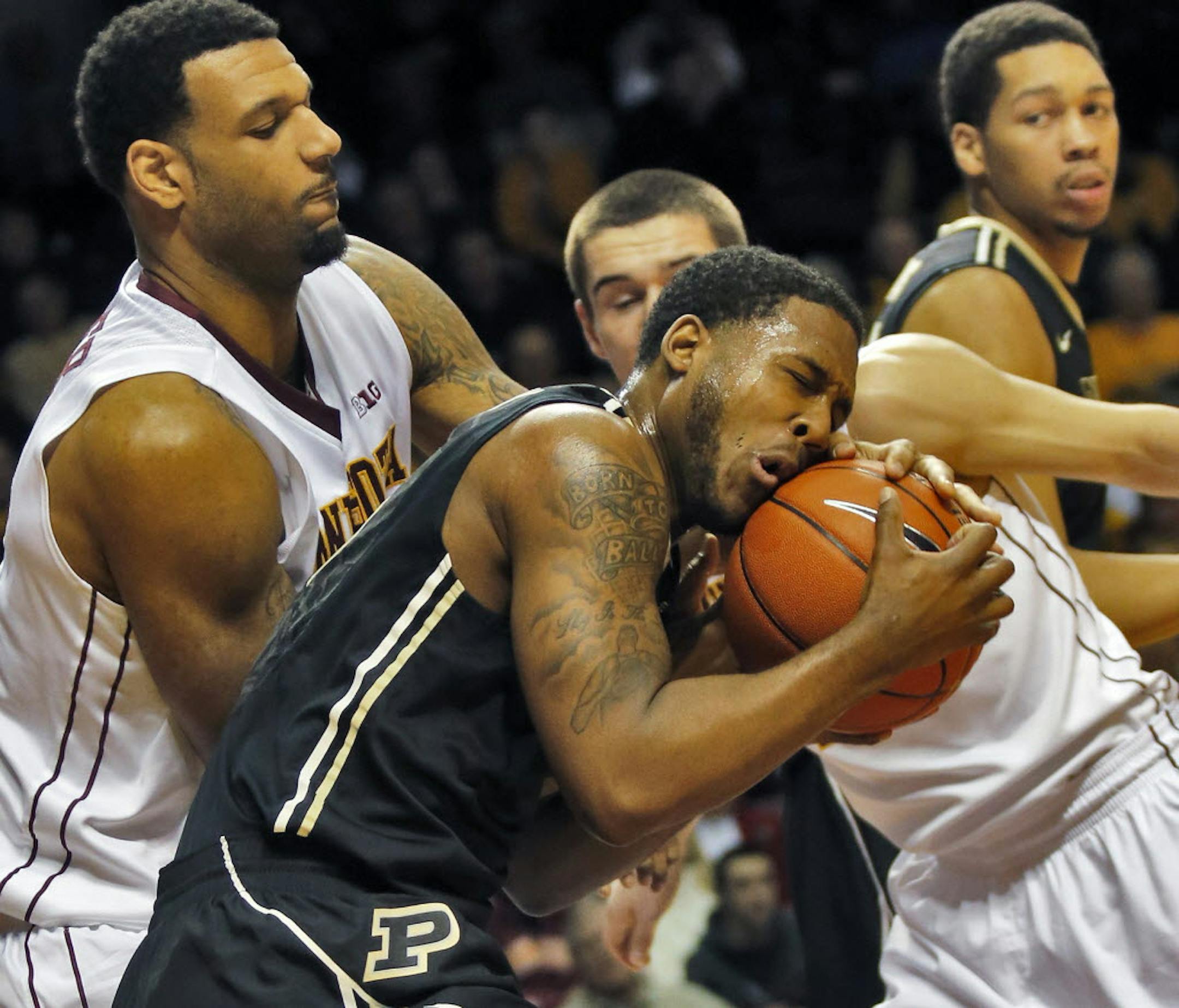Gophers center Mo Walker, left, and forward Joey King applied defensive pressure on Purdue's Terone Johnson.