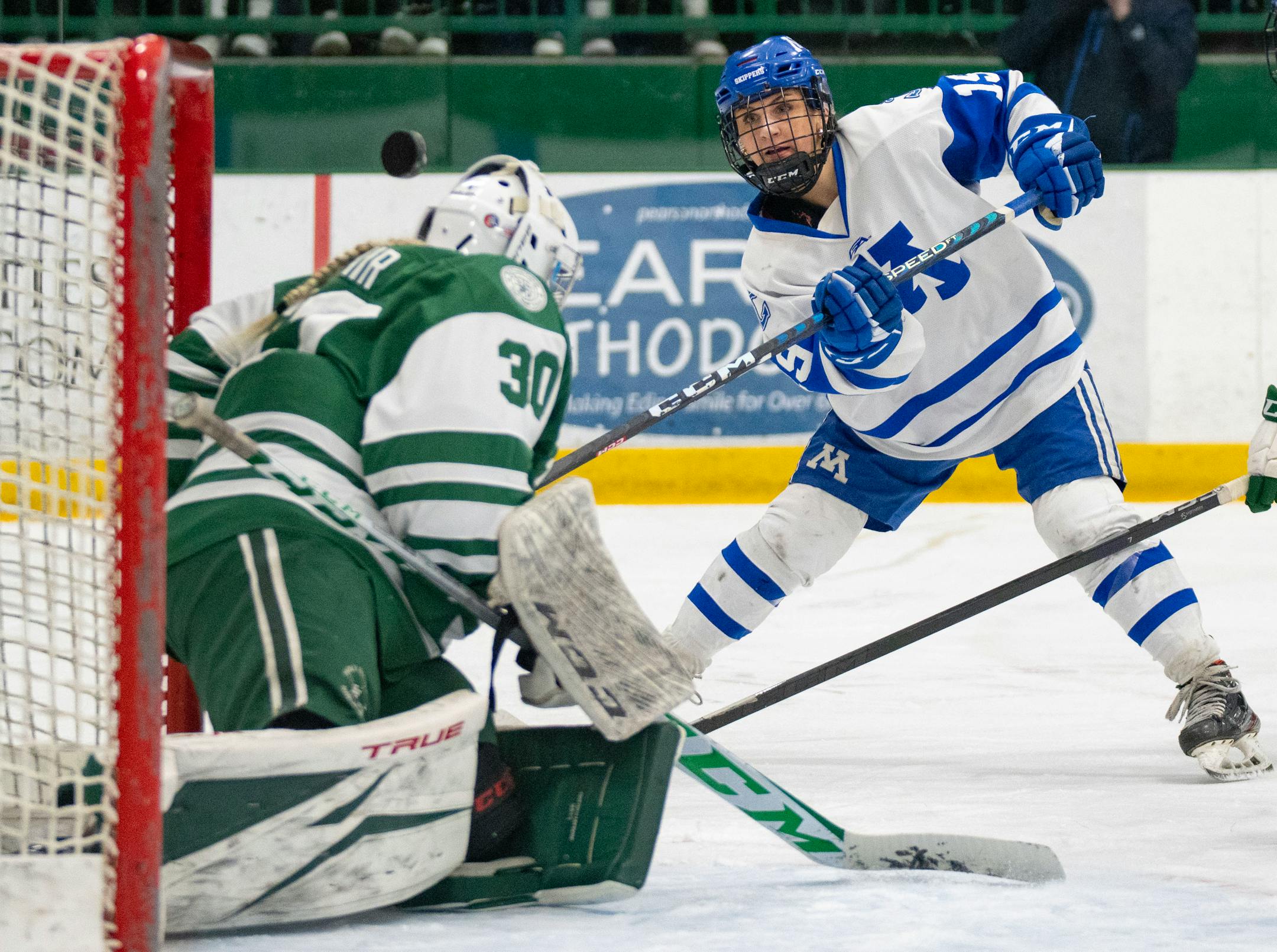 Minnetonka forward Lauren Mack (19) takes a shot on Holy Family goaltender Sedona Blair (30) during the first period.