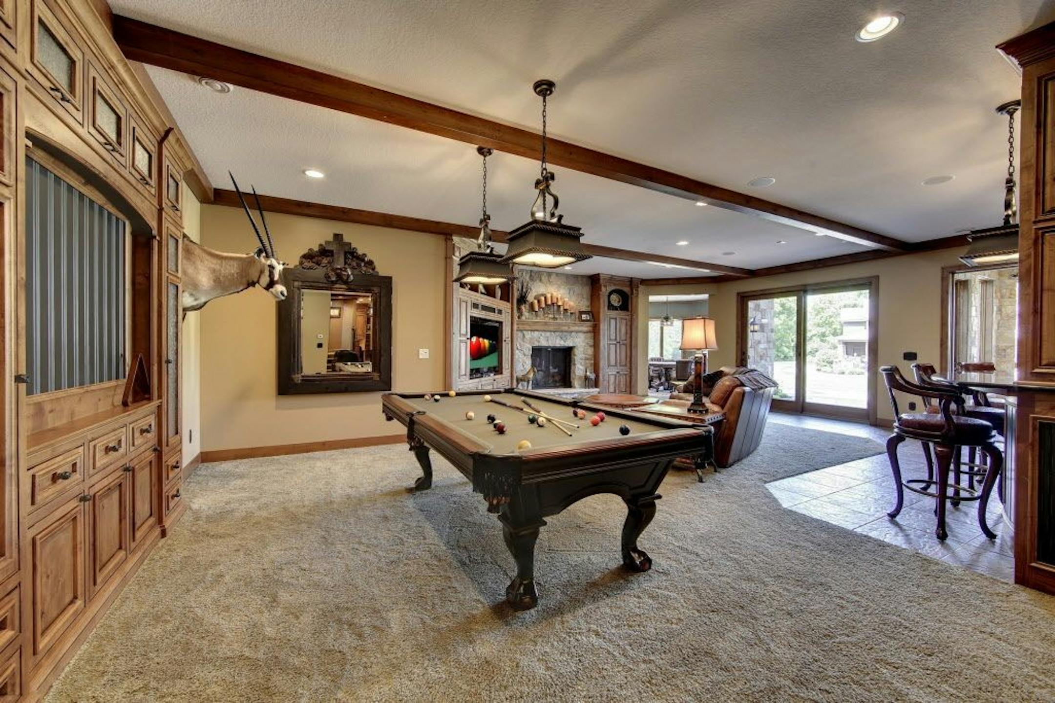 The lower level family room includes a built-in cabinet for pool cues.