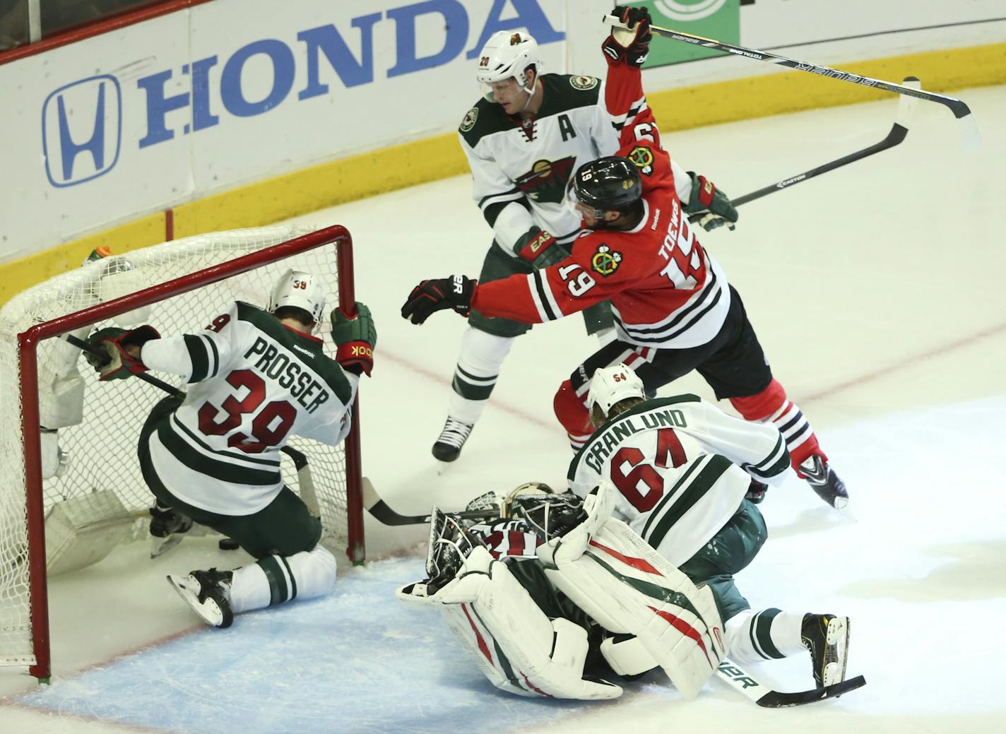 Minnesota Wild defenseman Nate Prosser (39) chases the puck into the goal as Chicago Blackhawks center Jonathan Toews (19) scores during the third period of their game Sunday night at United Center in Chicago. ] JEFF WHEELER &#x201a;&#xc4;&#xa2; jeff.wheeler@startribune.com The Minnesota Wild faced the Chicago Blackhawks in game 5 of their playoff series Sunday night, May 11, 2014 at United Center in Chicago.