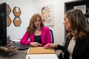 Prof. Natalie Netzel, left, co-director of the law clinics at Mitchell Hamline School of Law, met Friday with law student Hannah Burton to discuss her