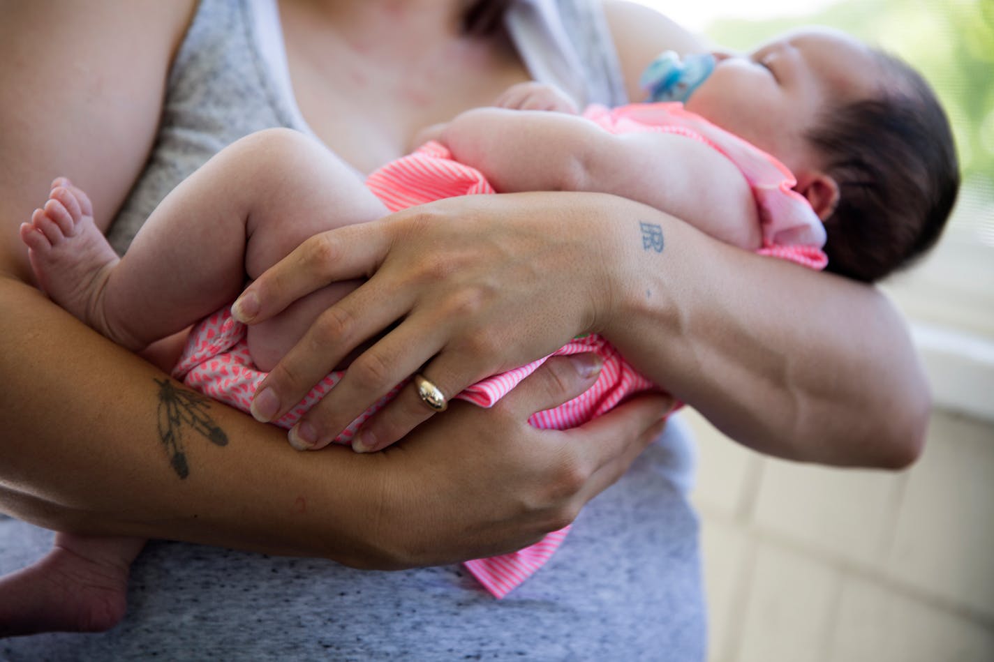 Raejean Icard rocks her two-month-old daughter Eniya at her mother's house in St. Paul the day she was released from Shakopee women's prison. Icard is hoping to be able to breastfeed her daughter, as she was able to pump milk in prison to keep up production.