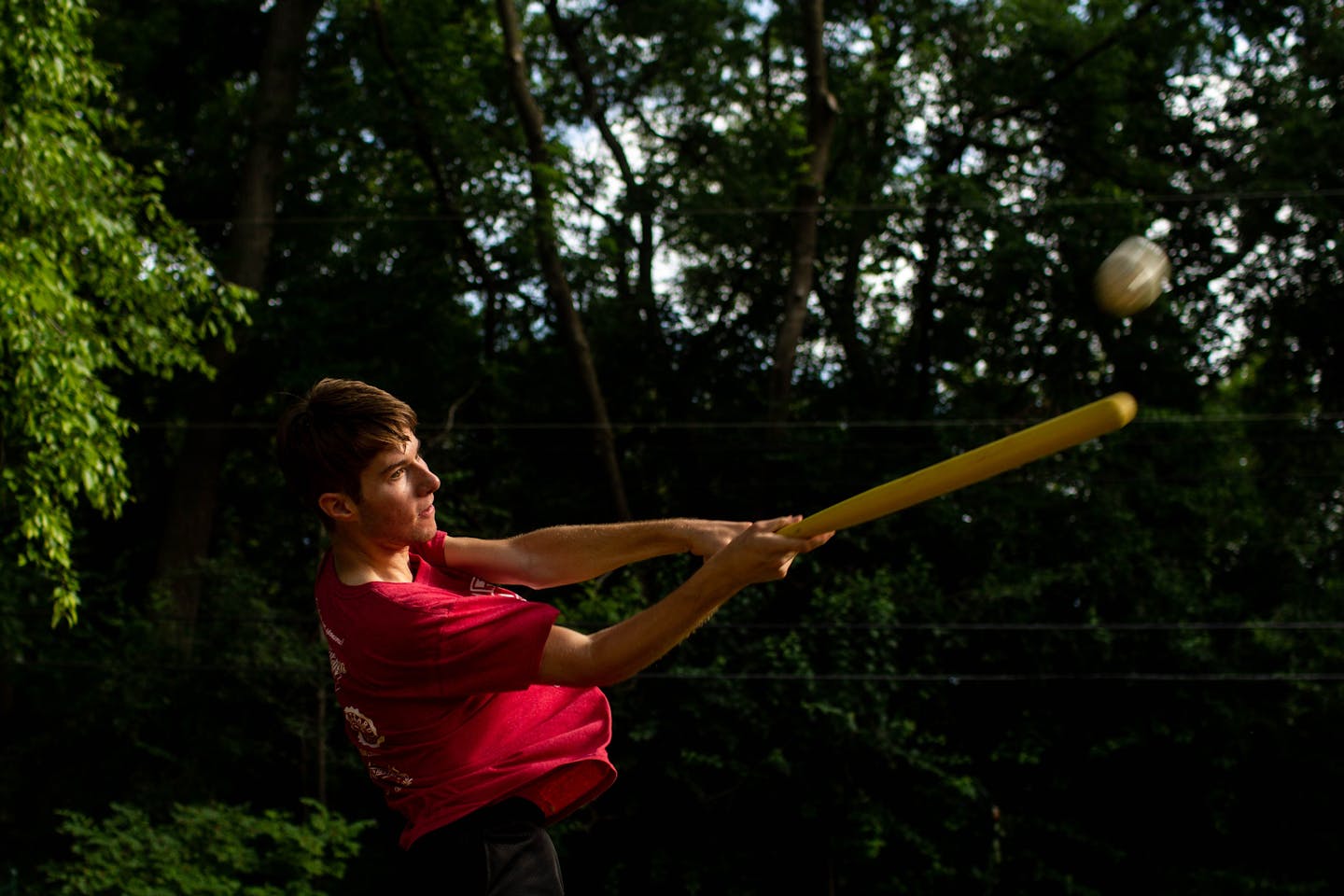 John Cronin, 20, hits a pitch from Andy Leihman, 20, over his neighbor's fence. ] NICOLE NERI &#x2022; nicole.neri@startribune.com BACKGROUND INFORMATION: John Cronin, 20, and Andy Leihman, 20, practice pitching and hitting wiffle balls in Cronin's backyard in St. Paul, the original baseball diamond for the ALS Wiffleball Tournament, Thursday, July 18, 2019.