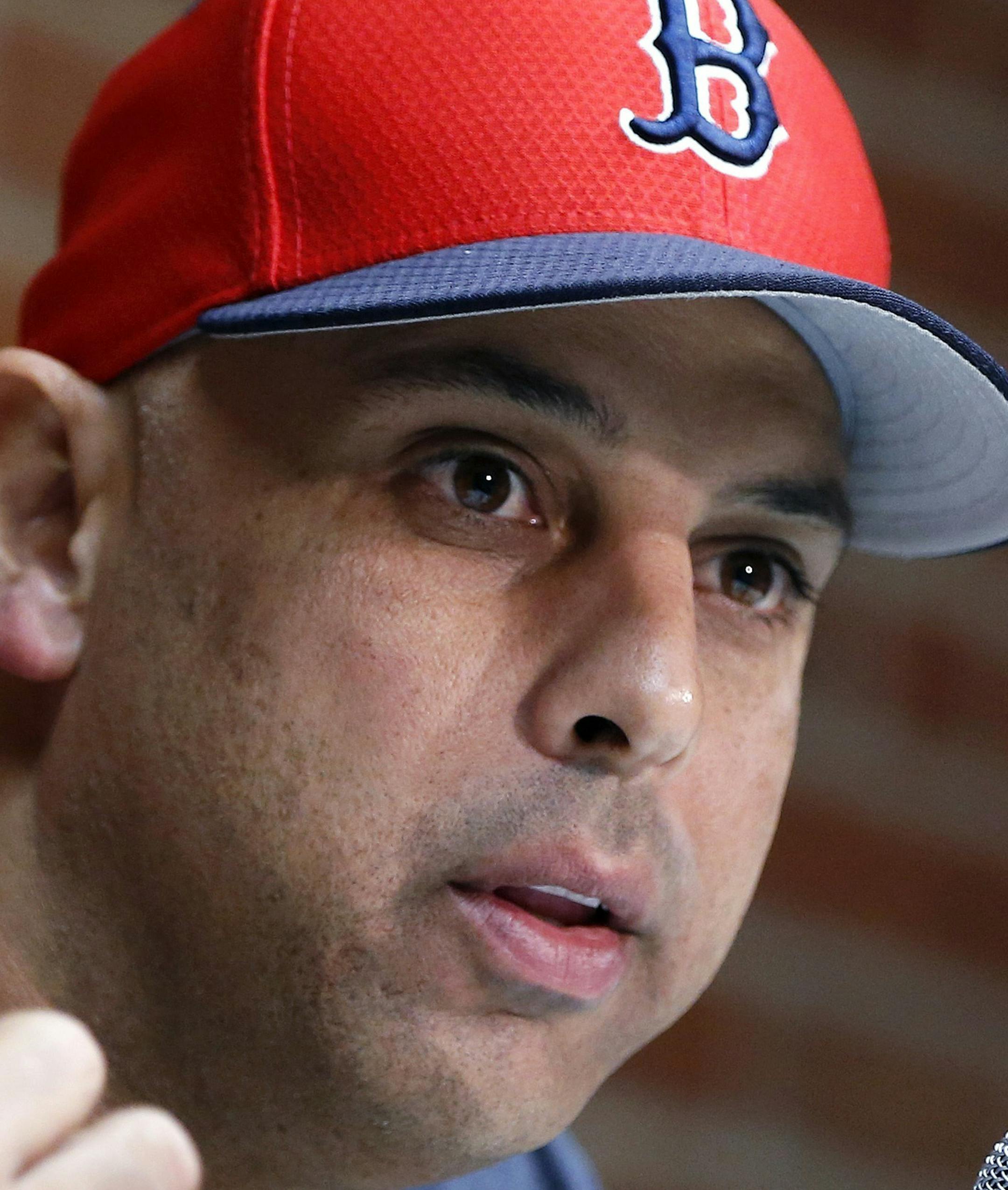 FILE&#x2014; In this Sept. 9, 2019, file photo, Boston Red Sox manager Alex Cora talks about the dismissal of president of baseball operations Dave Dombrowski, during a news conference before the team's baseball game against the New York Yankees in Boston. Cora was fired by the Red Sox on Tuesday, Jan. 14, 2020, a day after baseball Commissioner Rob Manfred implicated him in the sport's sign-stealing scandal. (AP Photo/Michael Dwyer, File)